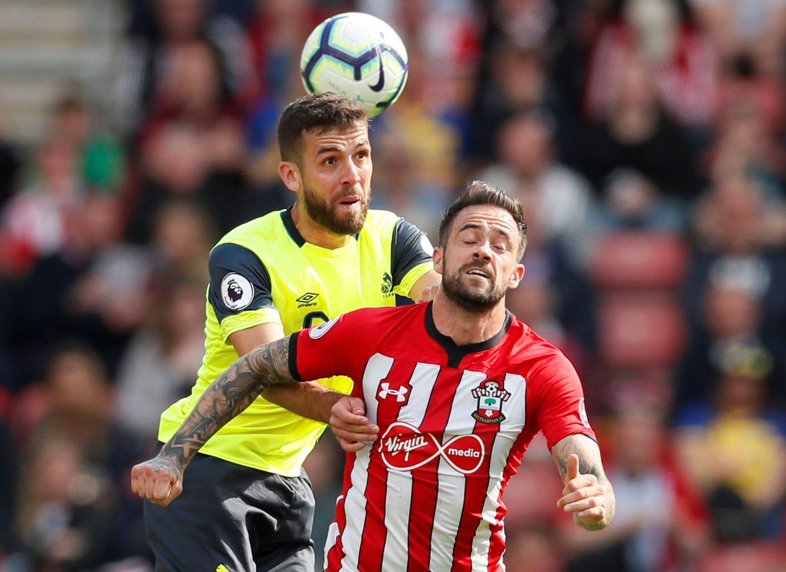 Soccer Football - Premier League - Southampton v Huddersfield Town - St Mary's Stadium, Southampton, Britain - May 12, 2019  Huddersfield Town's Tommy Smith in action with Southampton's Danny Ings   REUTERS/David Klein  EDITORIAL USE ONLY. No use with unauthorized audio, video, data, fixture lists, club/league logos or 