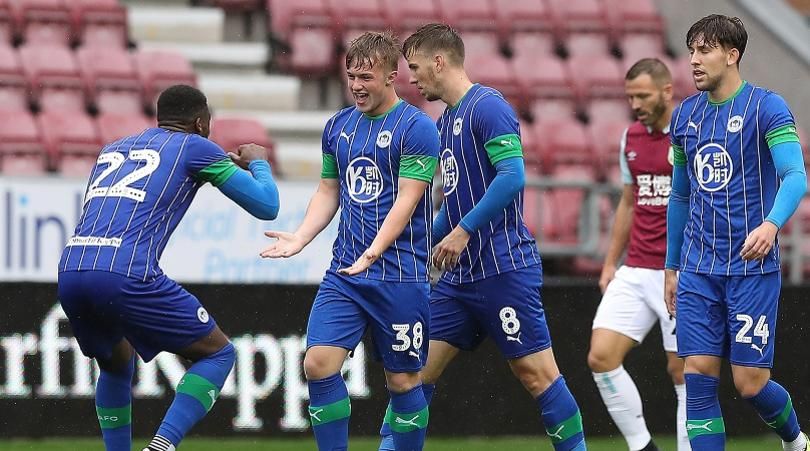 Wigan Athletic's Joe Gelhardt (2nd left) celebrates scoring his teams second goal against Burnley, during the pre-season friendly match at the DW Stadium, Wigan.