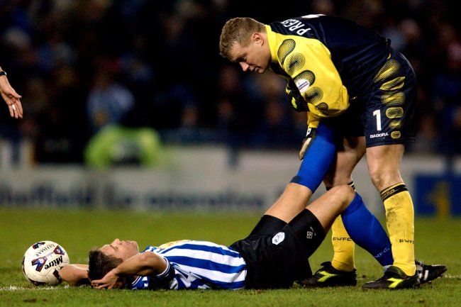 Sheffield Wednesday's captain Leigh Bromby is helped with his injury by team mate and goalkeeper Kevin Pressman