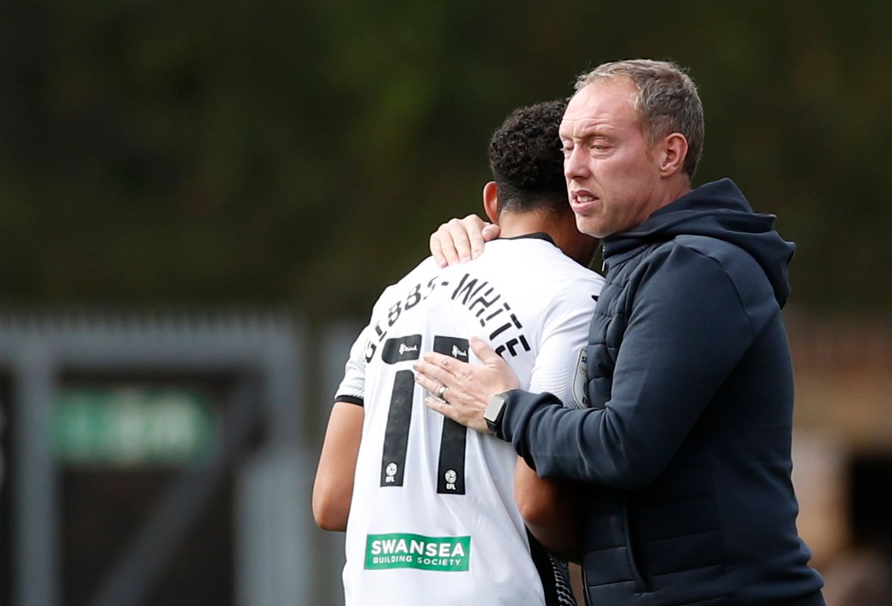 Soccer Football - Championship - Wycombe Wanderers v Swansea City - Adams Park, High Wycombe, Britain - September 26, 2020. Swansea City manager Steve Cooper hugs Swansea City's Morgan Gibbs-White after he is substituted. Action Images/Andrew Boyers EDITORIAL USE ONLY. No use with unauthorized audio, video, data, fixture lists, club/league logos or 'live' services. Online in-match use limited to 75 images, no video emulation. No use in betting, games or single club /league/player publications.  