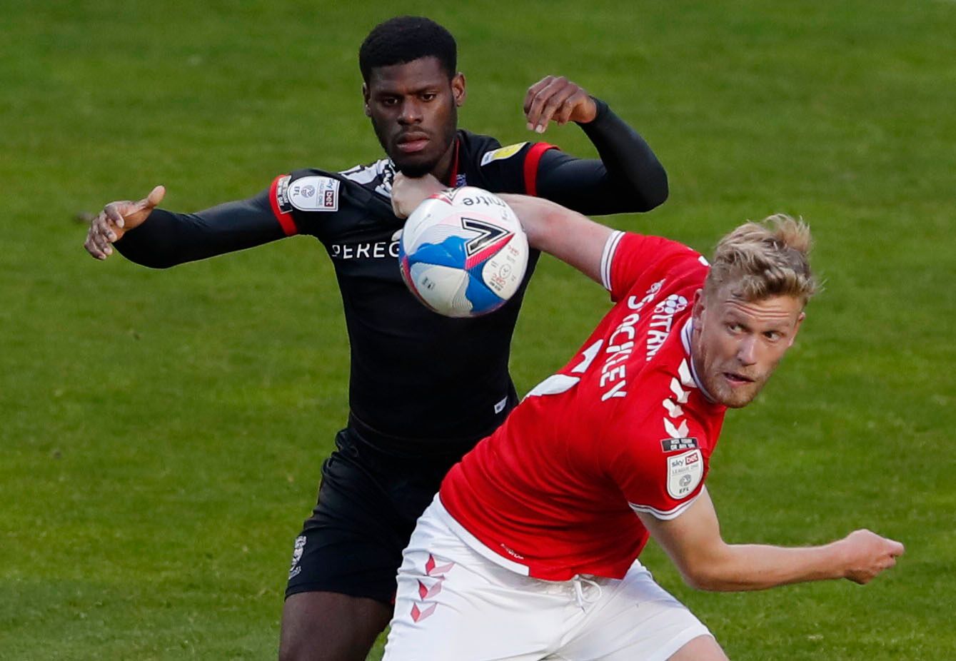 Soccer Football - League One - Charlton Athletic v Lincoln City - The Valley, London, Britain - May 4, 2021 Lincoln City's Timothy Eyoma in action with Charlton Athletic's Jayden Stockley Action Images/Andrew Couldridge EDITORIAL USE ONLY. No use with unauthorized audio, video, data, fixture lists, club/league logos or 'live' services. Online in-match use limited to 75 images, no video emulation. No use in betting, games or single club /league/player publications.  Please contact your account re