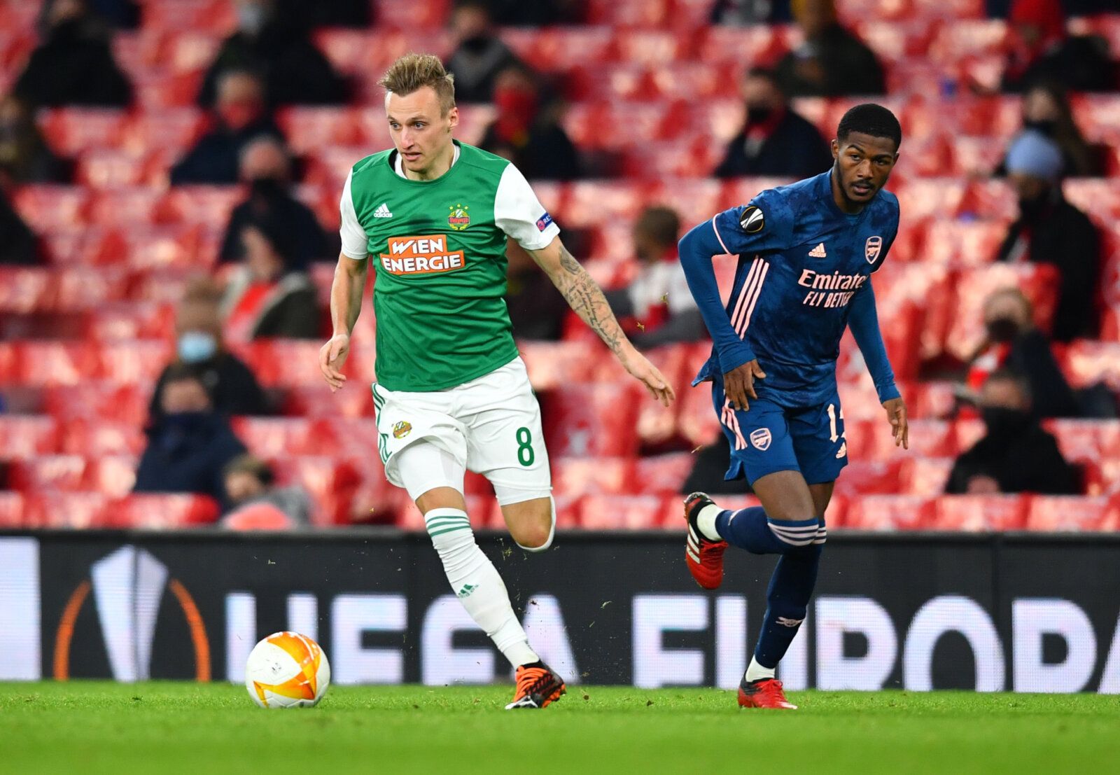 Soccer Football - Europa League - Group B - Arsenal v SK Rapid Wien - Emirates Stadium, London, Britain - December 3, 2020 SK Rapid Wien's Marcel Ritzmaier in action with Arsenal's Ainsley Maitland-Niles REUTERS/Dylan Martinez