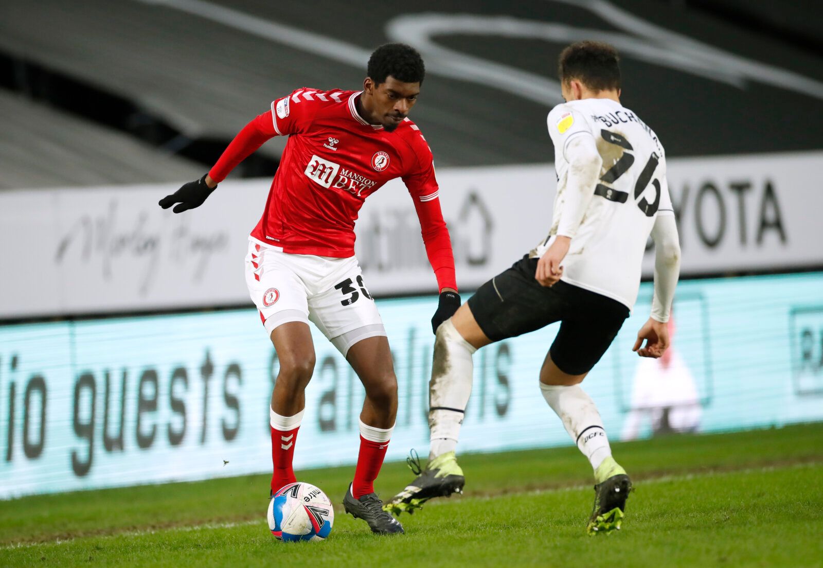 Soccer Football - Championship - Derby County v Bristol City - Pride Park, Derby, Britain - January 30, 2021 Bristol City's Tyreeq Bakinson in action with Derby County's Lee Buchanan Action Images/Andrew Boyers EDITORIAL USE ONLY. No use with unauthorized audio, video, data, fixture lists, club/league logos or 'live' services. Online in-match use limited to 75 images, no video emulation. No use in betting, games or single club /league/player publications.  Please contact your account representat
