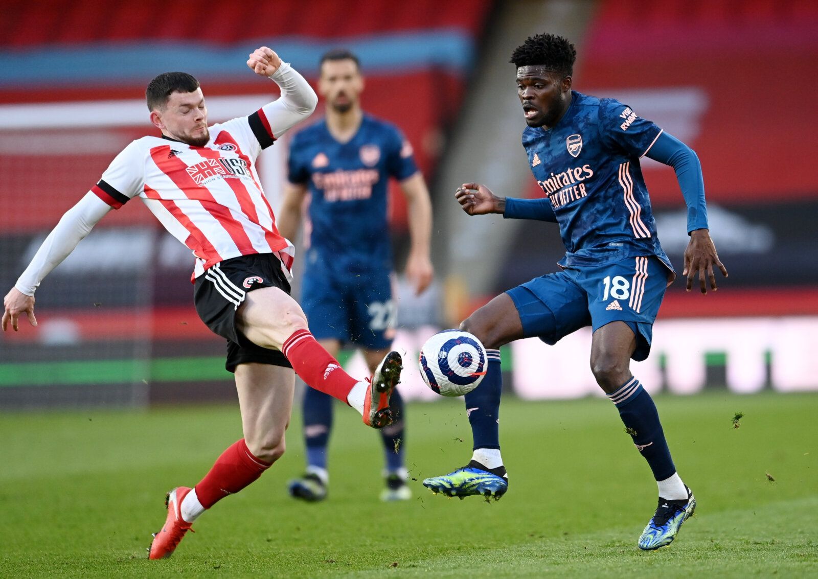 Soccer Football - Premier League - Sheffield United v Arsenal - Bramall Lane, Sheffield, Britain - April 11, 2021 Arsenal's Thomas Partey in action with Sheffield United's Oliver Burke Pool via REUTERS/Laurence Griffiths EDITORIAL USE ONLY. No use with unauthorized audio, video, data, fixture lists, club/league logos or 'live' services. Online in-match use limited to 75 images, no video emulation. No use in betting, games or single club /league/player publications.  Please contact your account r