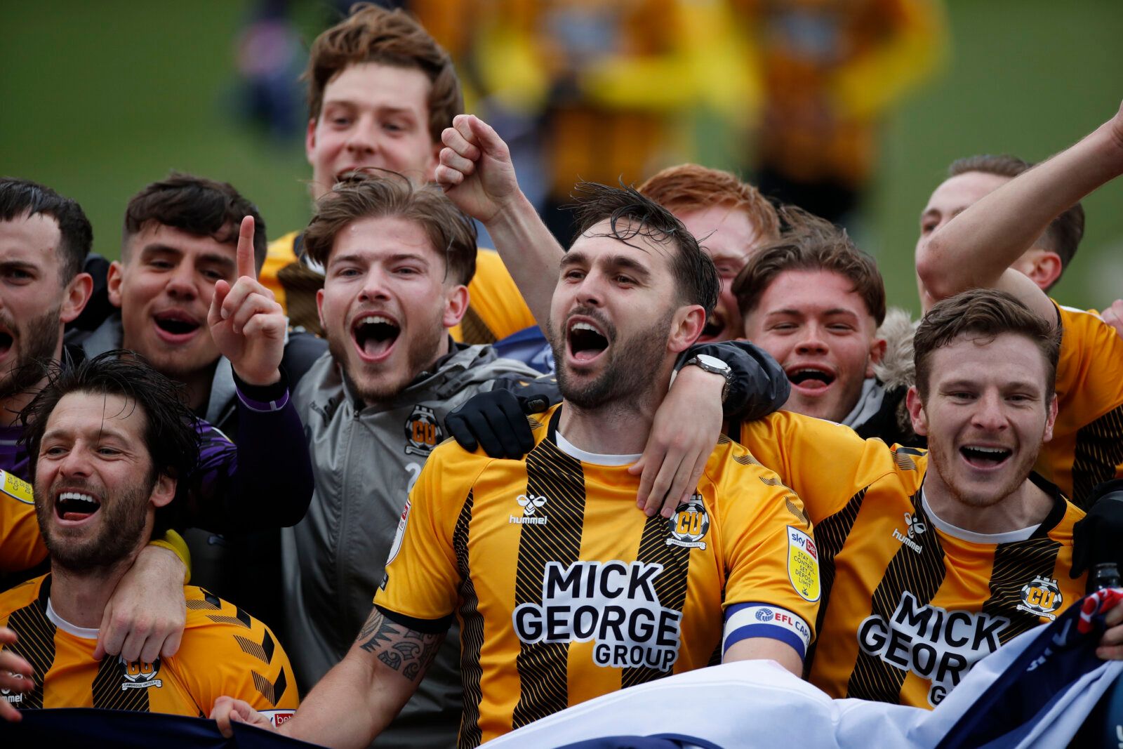Soccer Football - League Two - Cambridge United v Grimsby Town - Abbey Stadium, Cambridge, Britain - May 8, 2021 Cambridge's Wesley Hoolahan, Greg Taylor and Paul Mullin celebrate promotion to League One after the match with fans Action Images/Paul Childs EDITORIAL USE ONLY. No use with unauthorized audio, video, data, fixture lists, club/league logos or 'live' services. Online in-match use limited to 75 images, no video emulation. No use in betting, games or single club /league/player publicati