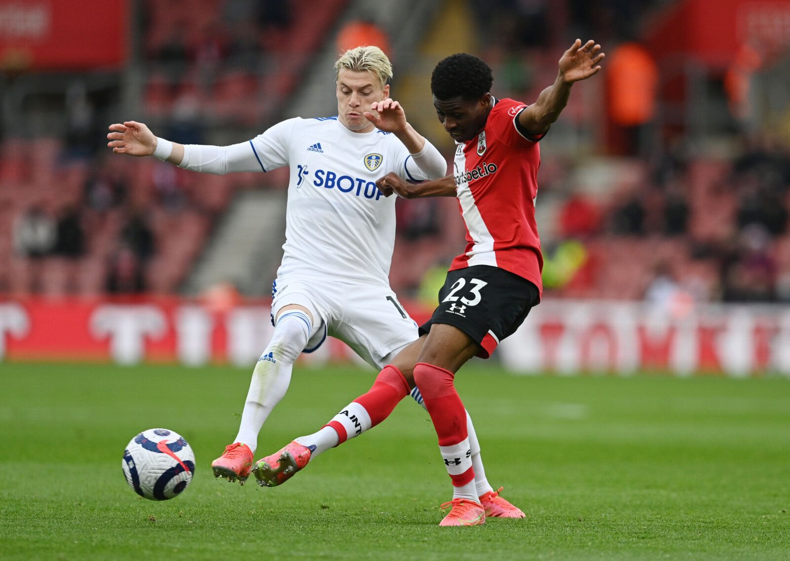 Soccer Football - Premier League -  Southampton v Leeds United - St Mary's Stadium, Southampton, Britain - May 18, 2021 Leeds United's Ezgjan Alioski in action with Southampton's Nathan Tella Pool via REUTERS/Neil Hall EDITORIAL USE ONLY. No use with unauthorized audio, video, data, fixture lists, club/league logos or 'live' services. Online in-match use limited to 75 images, no video emulation. No use in betting, games or single club /league/player publications.  Please contact your account rep