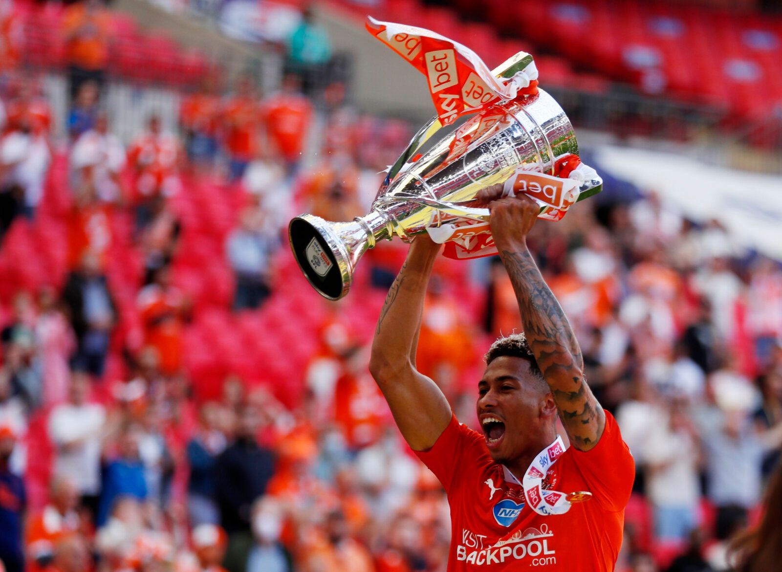 Soccer Football - League One Play-Off Final - Blackpool v Lincoln City - Wembley Stadium, London, Britain - May 30, 2021  Blackpool's Jordan Gabriel celebrates with the trophy after winning the League One Play-Off Final Action Images/Lee Smith EDITORIAL USE ONLY. No use with unauthorized audio, video, data, fixture lists, club/league logos or 'live' services. Online in-match use limited to 75 images, no video emulation. No use in betting, games or single club /league/player publications.  Please