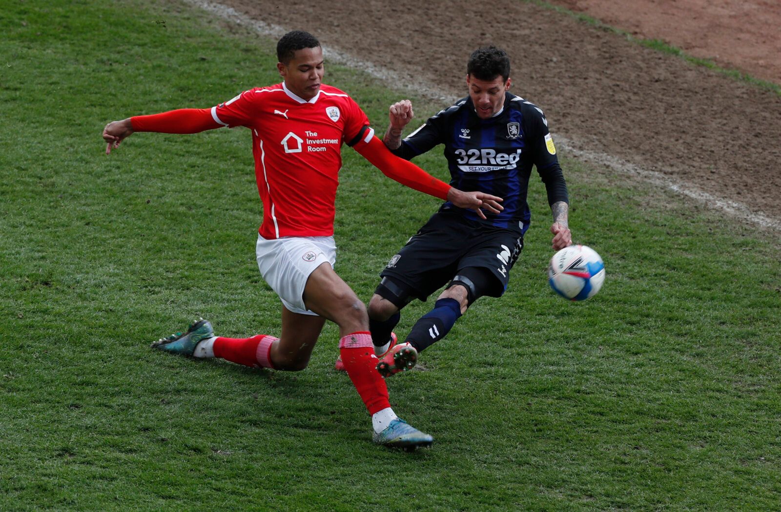 Soccer Football - Championship - Barnsley v Middlesbrough - Oakwell, Barnsley, Britain - April 10, 2021 Middlesbrough's Marvin Johnson in action with Barnsley's Toby Sibbick Action Images/Lee Smith EDITORIAL USE ONLY. No use with unauthorized audio, video, data, fixture lists, club/league logos or 'live' services. Online in-match use limited to 75 images, no video emulation. No use in betting, games or single club /league/player publications.  Please contact your account representative for furth
