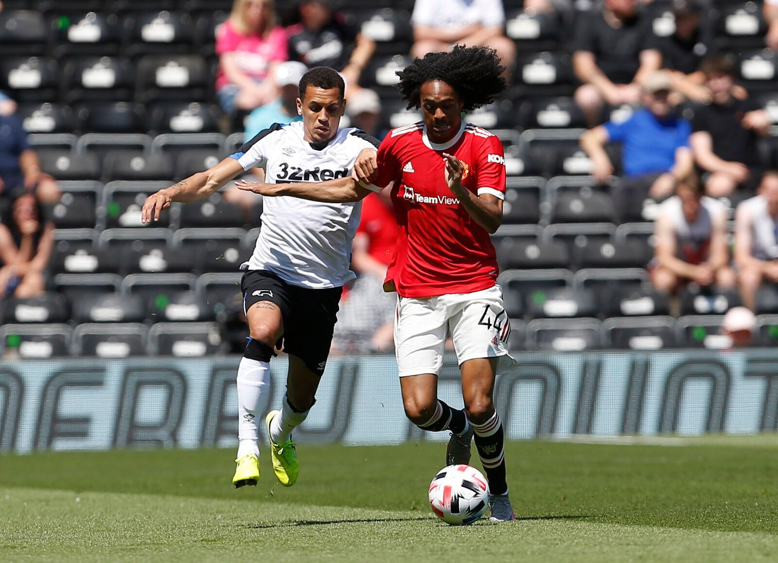 Soccer Football - Pre Season Friendly - Derby County v Manchester United - Pride Park, Derby, Britain - July 18, 2021 Manchester United's Tahith Chong in action with Derby County's Ravel Morrison Action Images via Reuters/Craig Brough