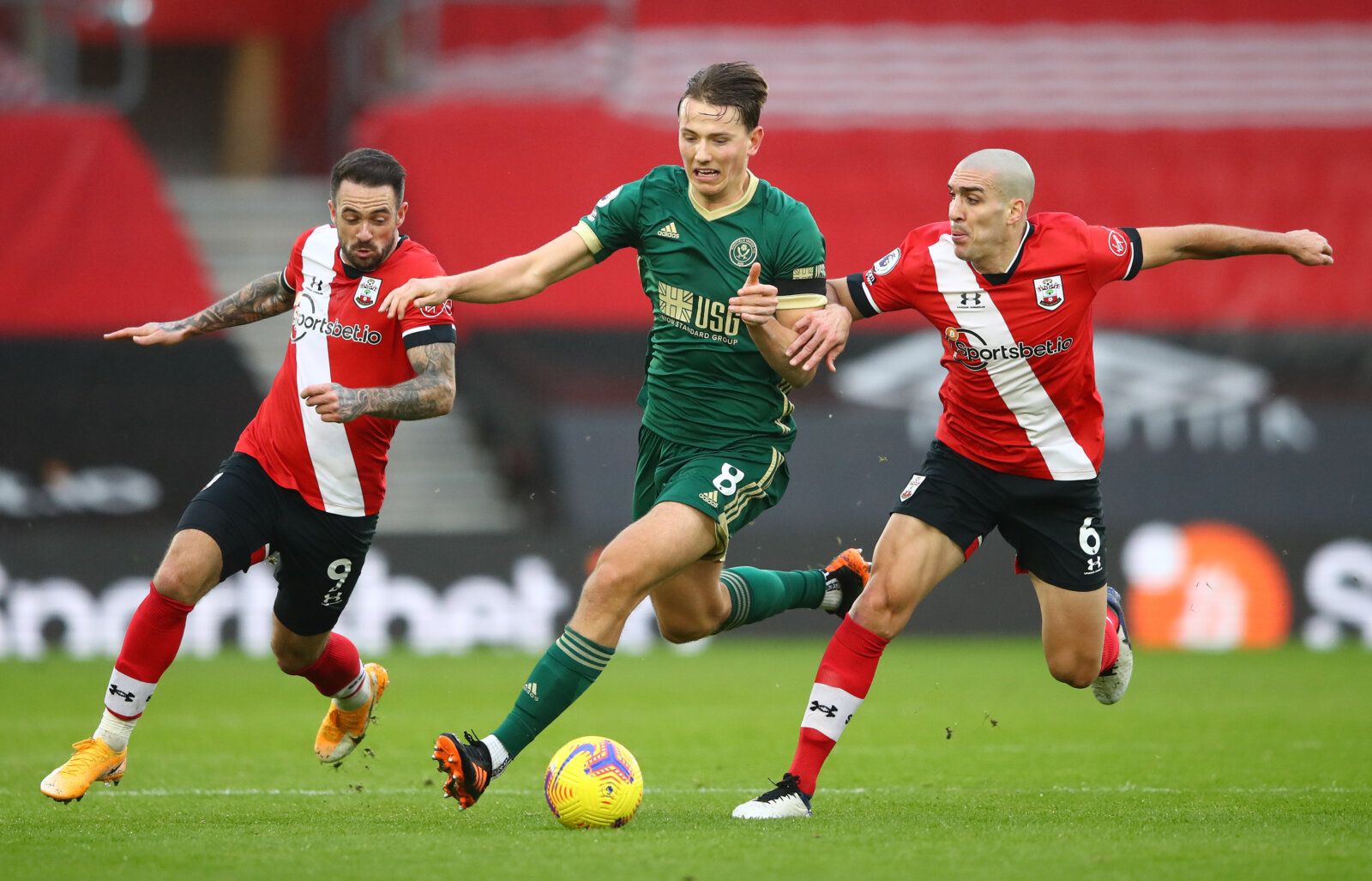 Soccer Football - Premier League - Southampton v Sheffield United - St Mary's Stadium, Southampton, Britain - December 13, 2020 Southampton's Oriol Romeu and Danny Ings in action with Sheffield United's Sander Berge Pool via REUTERS/Michael Steele EDITORIAL USE ONLY. No use with unauthorized audio, video, data, fixture lists, club/league logos or 'live' services. Online in-match use limited to 75 images, no video emulation. No use in betting, games or single club /league/player publications.  Pl