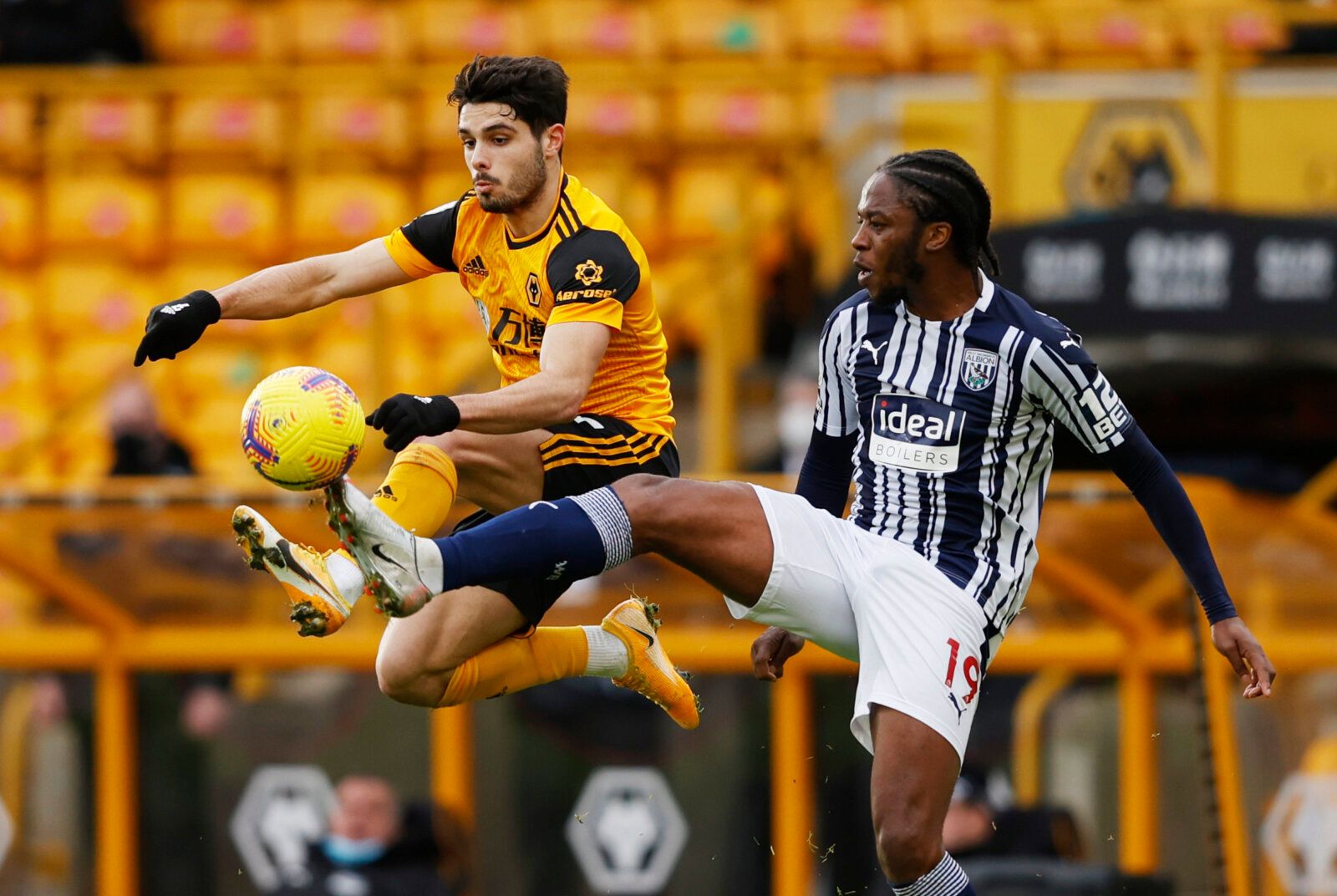 Soccer Football - Premier League - Wolverhampton Wanderers v West Bromwich Albion - Molineux Stadium, Wolverhampton, Britain - January 16, 2021 Wolverhampton Wanderers' Pedro Neto in action with West Bromwich Albion's Romaine Sawyers Pool via REUTERS/Adrian Dennis EDITORIAL USE ONLY. No use with unauthorized audio, video, data, fixture lists, club/league logos or 'live' services. Online in-match use limited to 75 images, no video emulation. No use in betting, games or single club /league/player 
