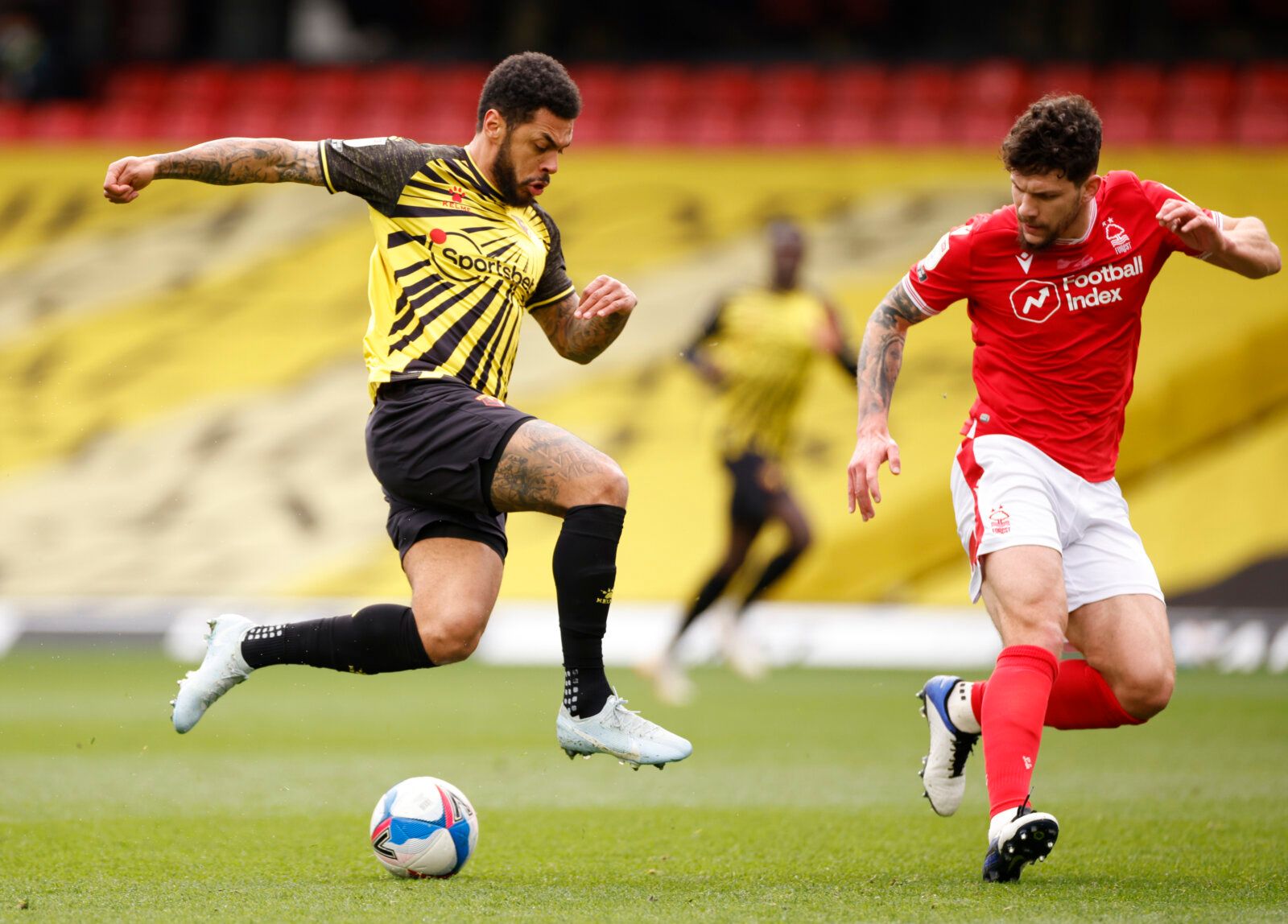 Soccer Football - Championship - Watford v Nottingham Forest - Vicarage Road, Watford, Britain - March 6, 2021 Watford's Andre Gray in action with Nottingham Forest’s Tobias Figueiredo Action Images/John Sibley EDITORIAL USE ONLY. No use with unauthorized audio, video, data, fixture lists, club/league logos or 'live' services. Online in-match use limited to 75 images, no video emulation. No use in betting, games or single club /league/player publications.  Please contact your account representat
