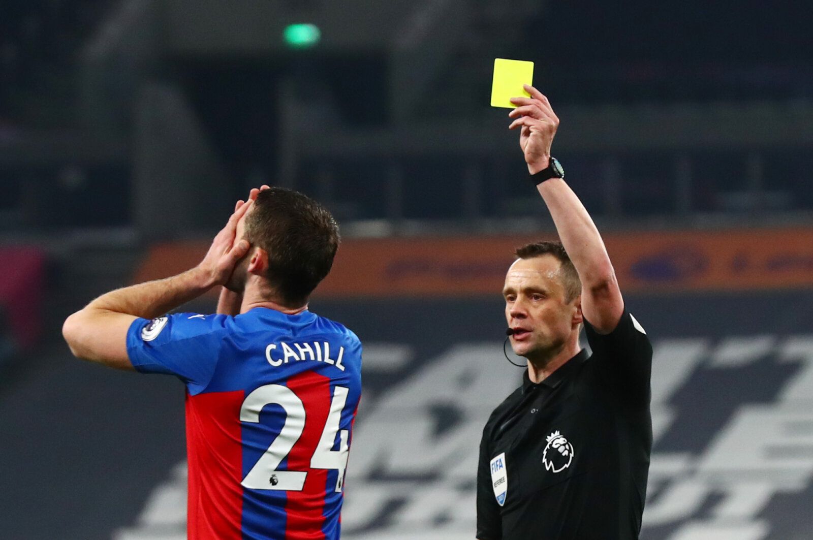 Soccer Football - Premier League - Tottenham Hotspur v Crystal Palace - Tottenham Hotspur Stadium, London, Britain - March 7, 2021 Crystal Palace's Gary Cahill reacts as he is shown a yellow card by referee Stuart Attwell Pool via REUTERS/Clive Rose EDITORIAL USE ONLY. No use with unauthorized audio, video, data, fixture lists, club/league logos or 'live' services. Online in-match use limited to 75 images, no video emulation. No use in betting, games or single club /league/player publications.  
