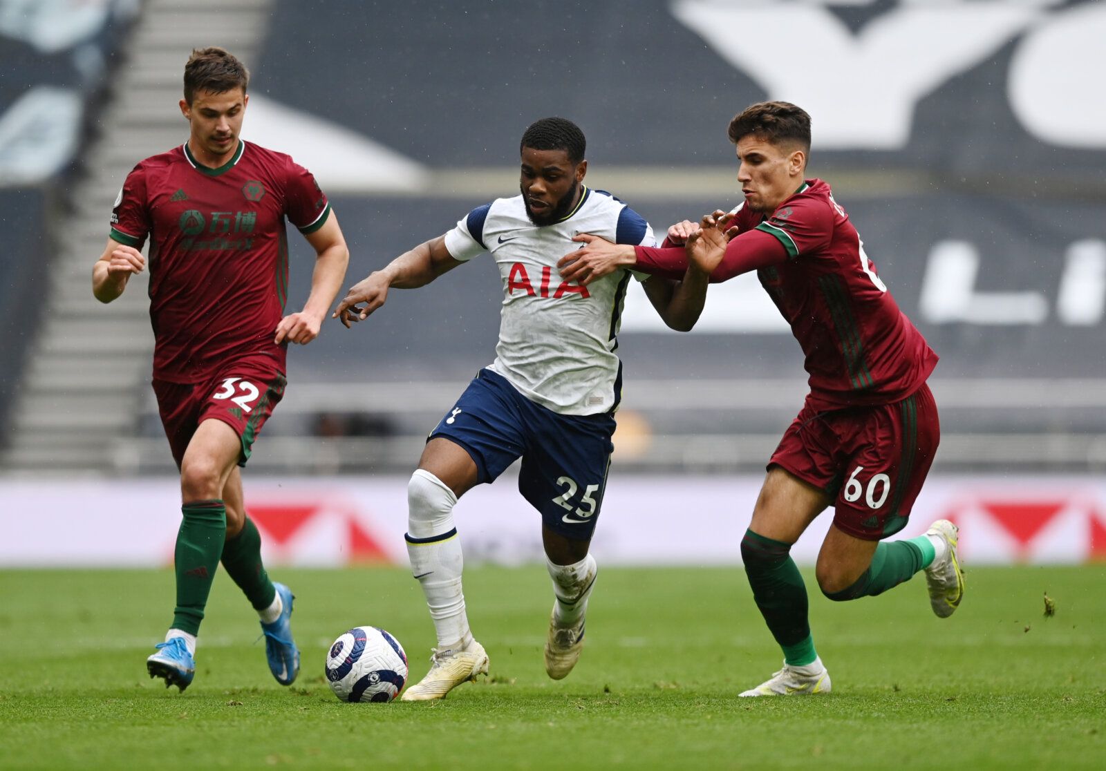 Soccer Football - Premier League - Tottenham Hotspur v Wolverhampton Wanderers - Tottenham Hotspur Stadium, London, Britain - May 16, 2021 Tottenham Hotspur's Japhet Tanganga in action with Wolverhampton Wanderers' Leander Dendoncker and Theo Corbeanu Pool via REUTERS/Shaun Botterill EDITORIAL USE ONLY. No use with unauthorized audio, video, data, fixture lists, club/league logos or 'live' services. Online in-match use limited to 75 images, no video emulation. No use in betting, games or single 