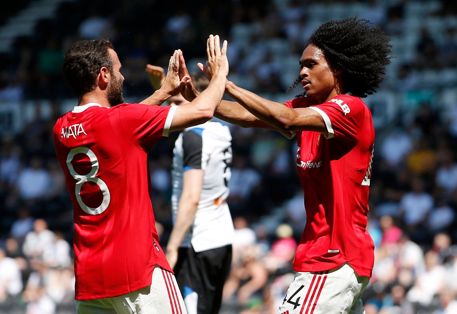 Soccer Football - Pre Season Friendly - Derby County v Manchester United - Pride Park, Derby, Britain - July 18, 2021 Manchester United's Tahith Chong celebrates scoring their first goal with Juan Mata Action Images via Reuters/Craig Brough
