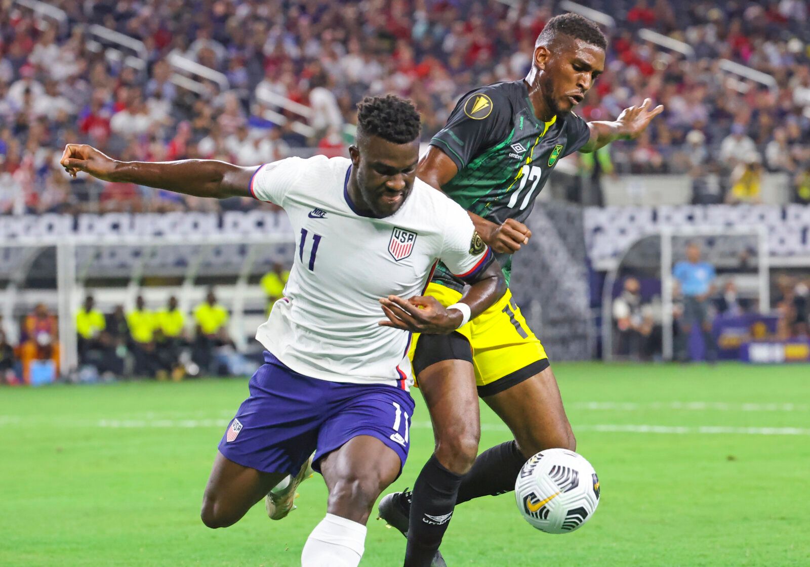 Jul 25, 2021; Arlington, Texas, USA; United States forward Daryl Dike (11) and Jamaica defender Damion Lowe (17)  battle for the ball during the first half of a CONCACAF Gold Cup quarterfinal soccer match at AT&amp;T Stadium. Mandatory Credit: Kevin Jairaj-USA TODAY Sports