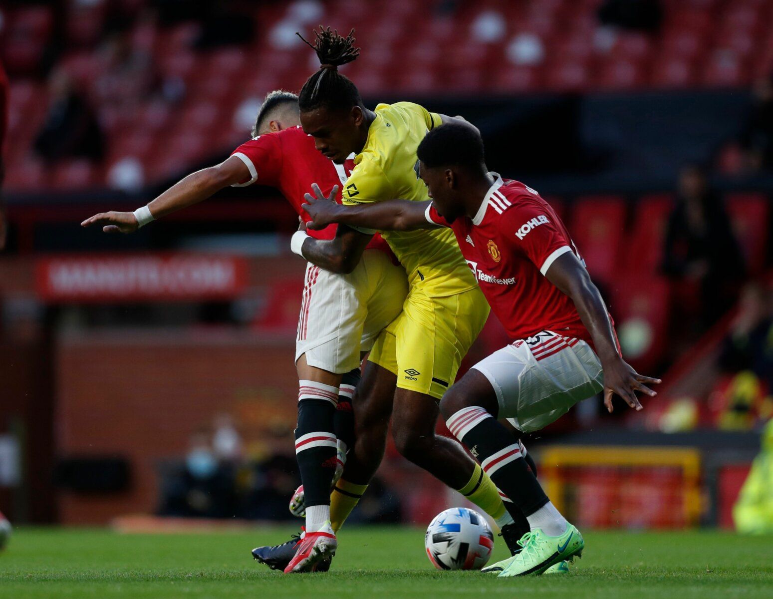 Soccer Football - Pre Season Friendly - Manchester United v Brentford - Old Trafford, Manchester, Britain - July 28, 2021  Brentford's Ivan Toney in action with Manchester United's Andreas Pereira and Teden Mengi Action Images via Reuters/Lee Smith