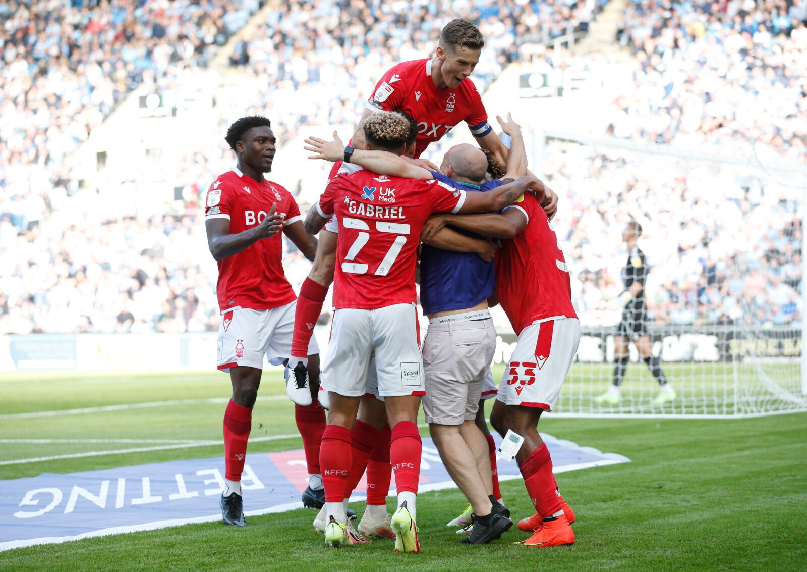 Soccer Football - Championship - Coventry City v Nottingham Forest - Coventry Building Society Arena, Coventry, Britain - August 8, 2021 Nottingham Forest's Lyle Taylor celebrates scoring their first goal with teammates as a pitch invader runs onto the pitch Action Images/Ed Sykes