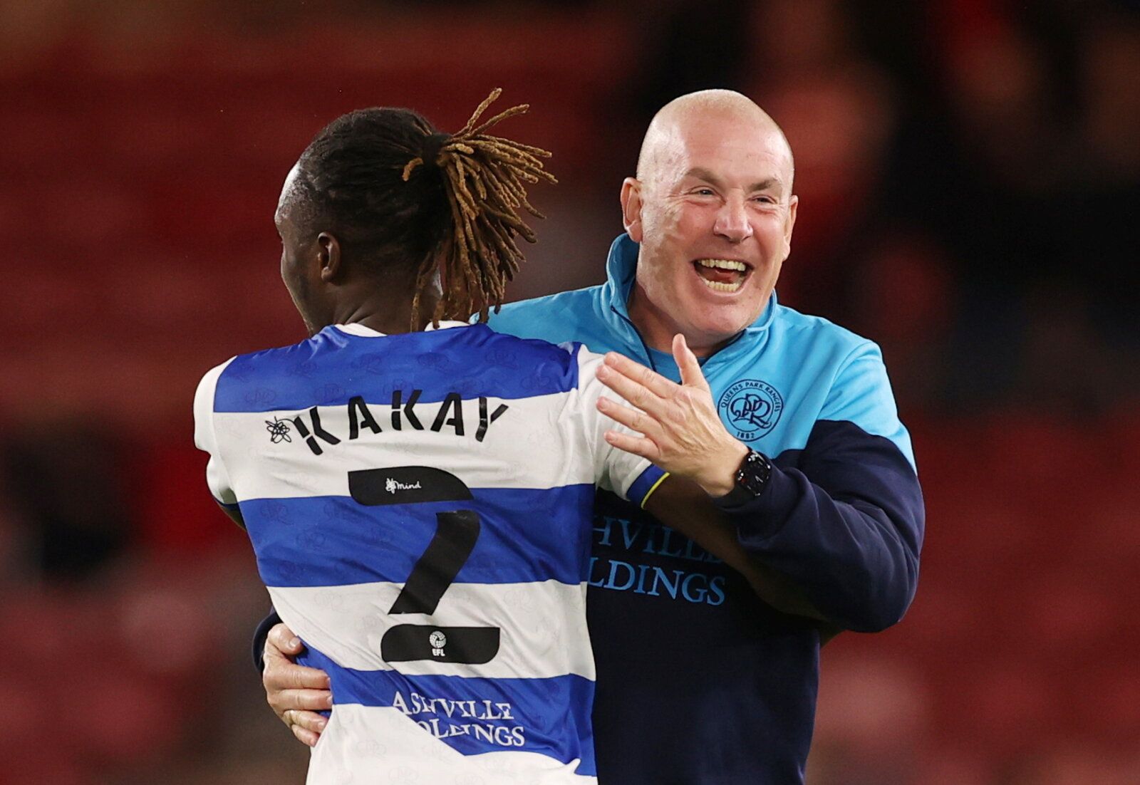 Soccer Football - Championship - Middlesbrough v Queens Park Rangers - Riverside Stadium, Middlesbrough, Britain - August 18, 2021  QPR manager Mark Warburton celebrates with Osman Kakay after the match    Action Images/Lee Smith  EDITORIAL USE ONLY. No use with unauthorized audio, video, data, fixture lists, club/league logos or 