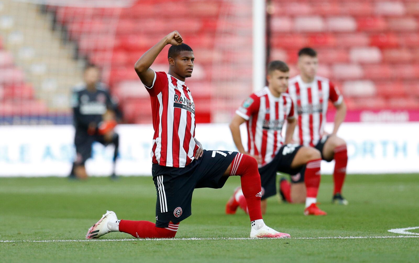Soccer Football - Carabao Cup - First Round - Sheffield United v Carlisle United - Bramall Lane, Sheffield, Britain - August 10, 2021 Sheffield United's Rhian Brewster kneels in support of the Black Lives Matter campaign before the match Action Images/Ed Sykes EDITORIAL USE ONLY. No use with unauthorized audio, video, data, fixture lists, club/league logos or 'live' services. Online in-match use limited to 75 images, no video emulation. No use in betting, games or single club /league/player publ