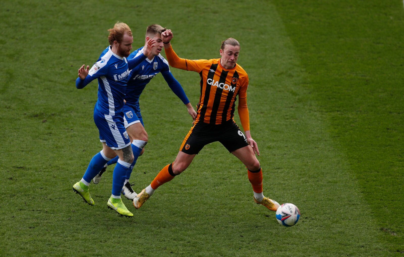 Soccer Football - League One - Hull City v Gillingham - KCOM Stadium, Hull, Britain - March 27, 2021 Hull City's  Tom Eaves in action with Gillinham's Connor Ogilvie Action Images/Lee Smith EDITORIAL USE ONLY. No use with unauthorized audio, video, data, fixture lists, club/league logos or 'live' services. Online in-match use limited to 75 images, no video emulation. No use in betting, games or single club /league/player publications.  Please contact your account representative for further detai