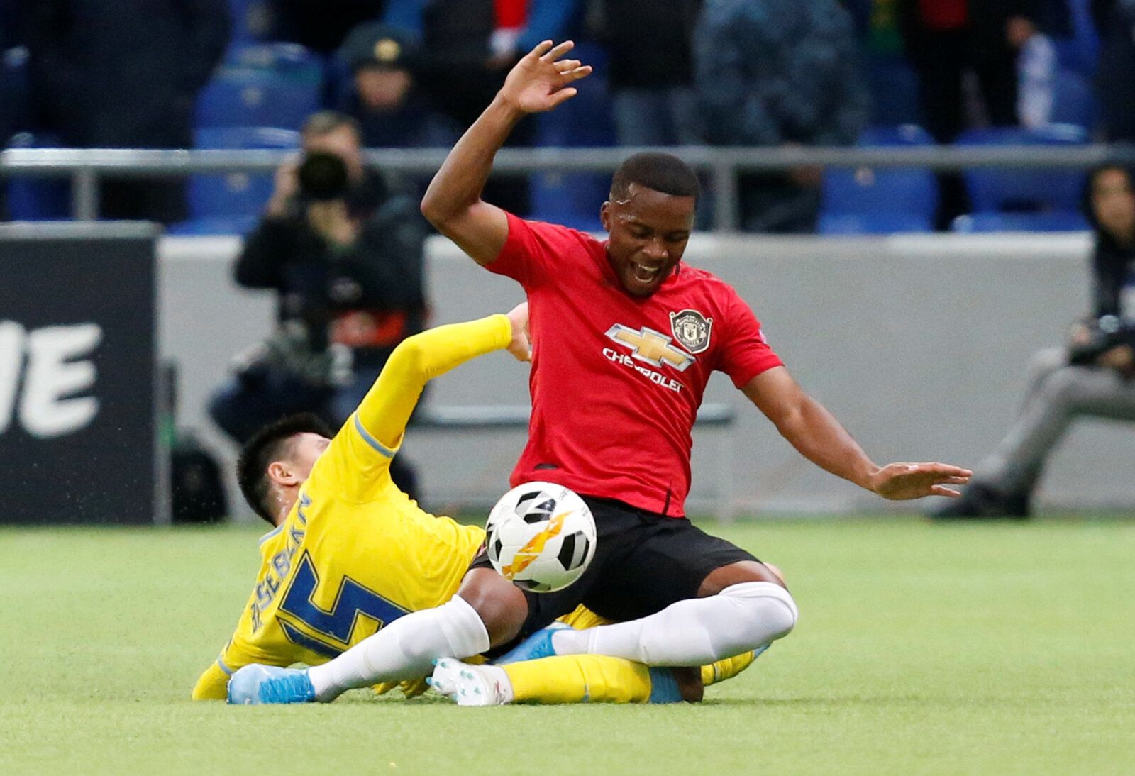 Soccer Football - Europa League - Group L - Astana v Manchester United - Astana Arena, Nur-Sultan, Kazakhstan - November 28, 2019  Manchester United's Ethan Laird in action with Astana's Abzal Beysebekov   REUTERS/Pavel Mikheyev