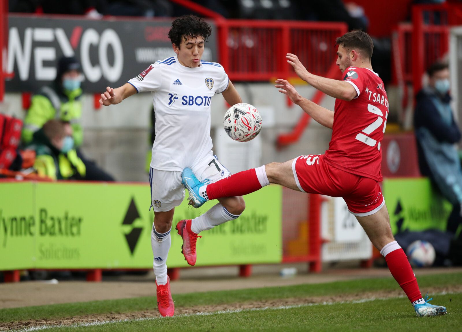 Soccer Football - FA Cup - Third Round - Crawley Town v Leeds United - The People's Pension Stadium, Crawley, Britain - January 10, 2021 Crawley Town's Nicholas Tsaroulla in action with Leeds United's Ian Poveda Action Images via Reuters/Peter Cziborra