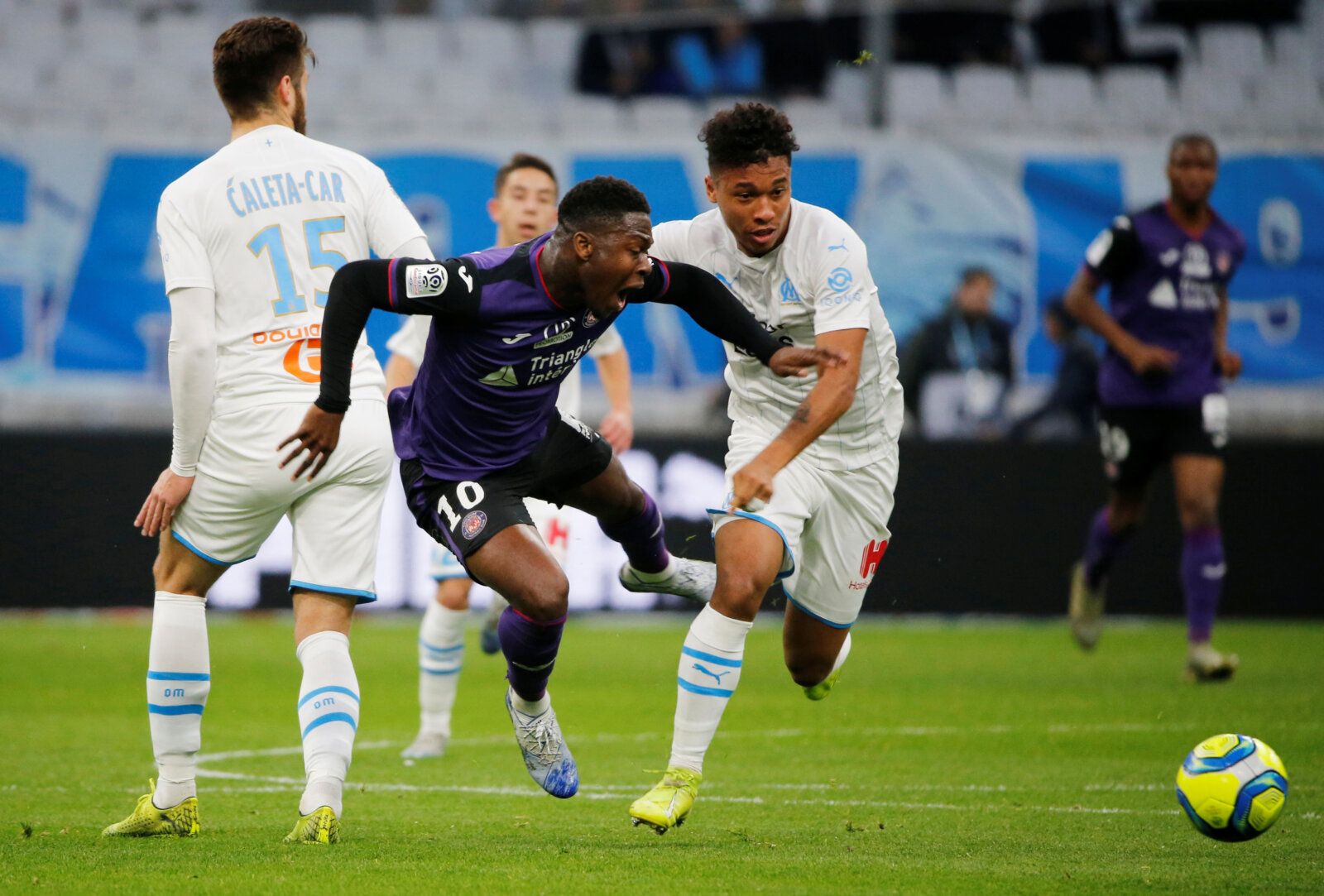 Soccer Football - Ligue 1 - Olympique de Marseille v Toulouse - Orange Velodrome, Marseille, France - February 8, 2020  Toulouse's Aaron Leya Iseka in action with Olympique de Marseille's Duje Caleta Car and Boubacar Kamara   REUTERS/Jean-Paul Pelissier
