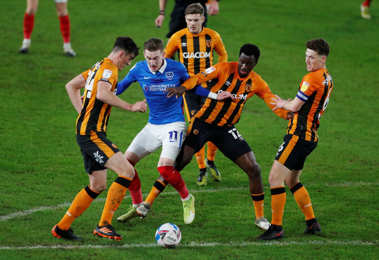 Soccer Football - League One - Hull City v Portsmouth- KCOM Stadium, Hull, Britain - December 18, 2020  Portsmouth's Ronan Curtis in action with Hull City's Richard Smallwood, Joshua Emmanuel and Jacob Greaves   Action Images/Lee Smith  EDITORIAL USE ONLY. No use with unauthorized audio, video, data, fixture lists, club/league logos or 