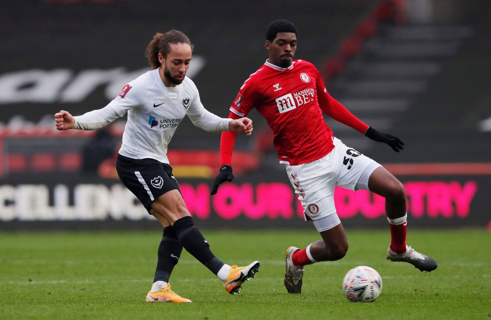 Soccer Football - FA Cup - Third Round - Bristol City v Portsmouth - Ashton Gate Stadium, Bristol, Britain - January 10, 2021 Portsmouths' Marcus Harness in action with Bristol City's Tyreeq Bakinson Action Images via Reuters/Andrew Couldridge