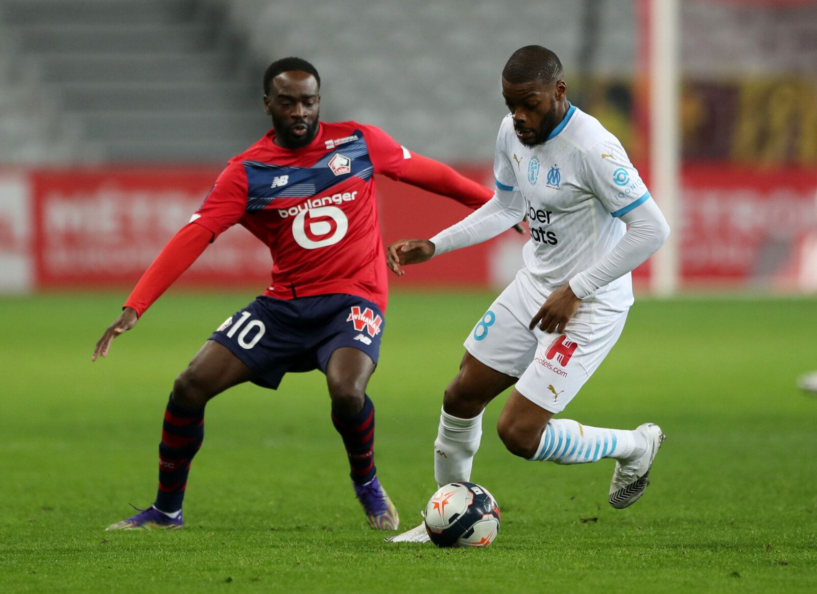 Soccer Football - Ligue 1 - Lille v Olympique de Marseille - Stade Pierre-Mauroy, Lille, France - March 3, 2021 Lille's Jonathan Ikone in action with Olympique de Marseille's Olivier Ntcham REUTERS/Pascal Rossignol
