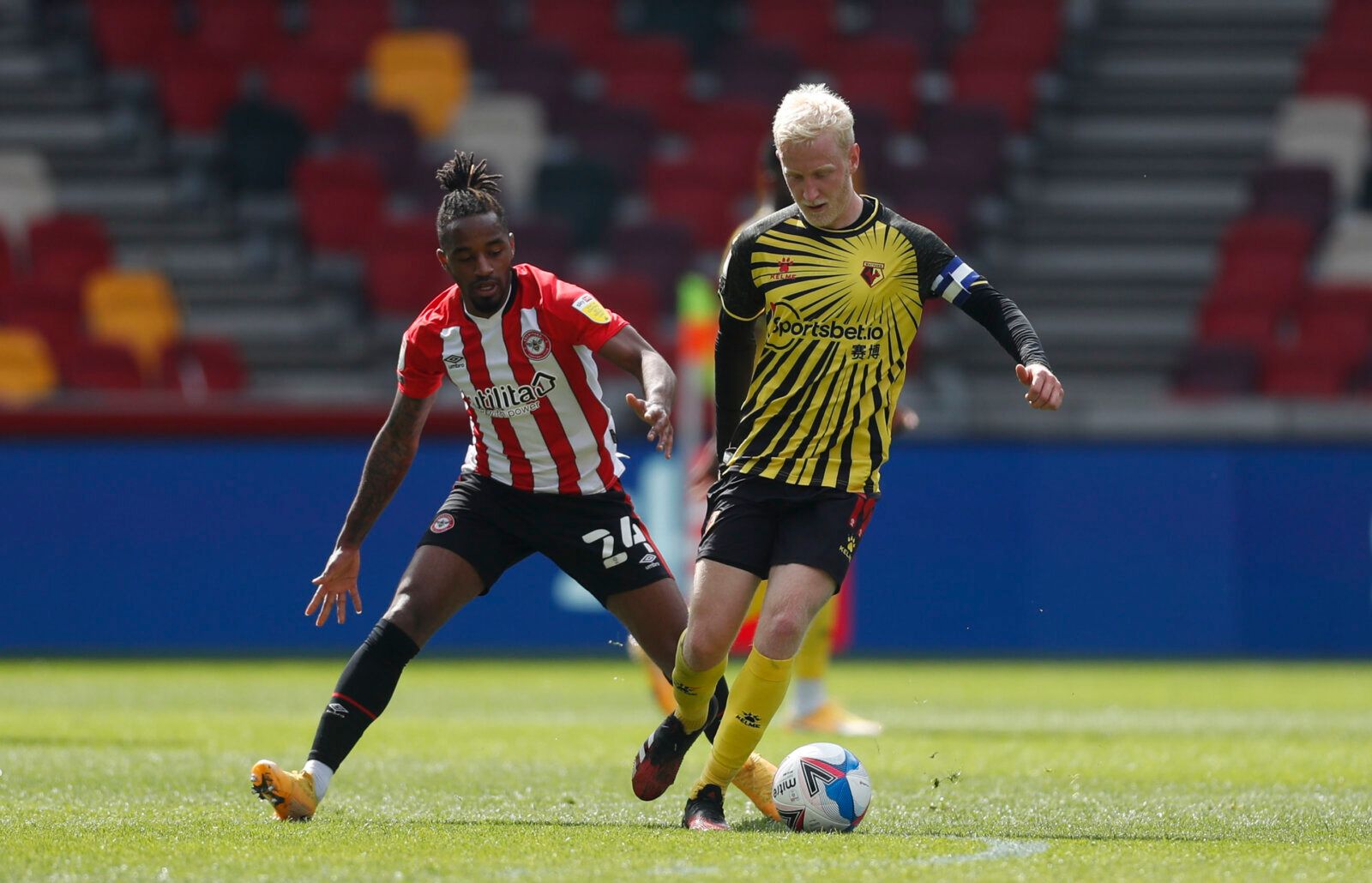 Soccer Football - Championship - Brentford v Watford - Brentford Community Stadium, London, Britain - May 1, 2021 Brentford's Tariqe Fosu in action with Watford's Will Hughes Action Images/Matthew Childs EDITORIAL USE ONLY. No use with unauthorized audio, video, data, fixture lists, club/league logos or 'live' services. Online in-match use limited to 75 images, no video emulation. No use in betting, games or single club /league/player publications.  Please contact your account representative for