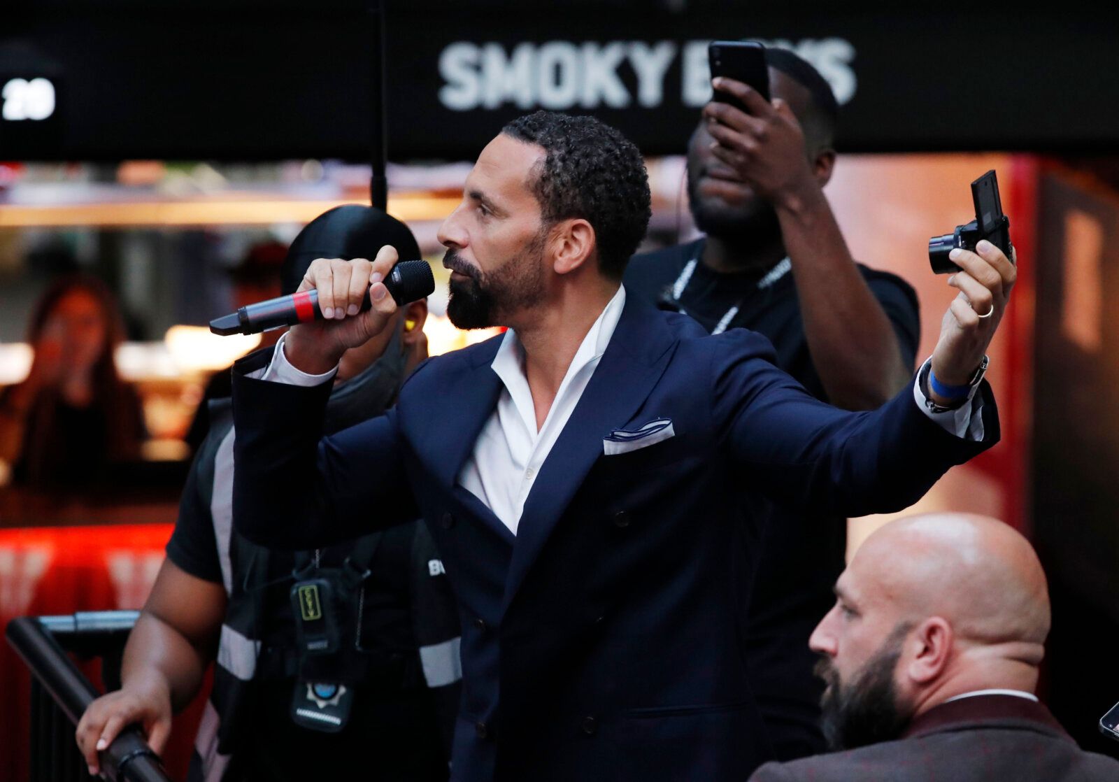 Soccer Football - Euro 2020 - Fans gather for England v Denmark - Boxpark, Wembley, London, Britain - July 7, 2021 Former player Rio Ferdinand talks to the crowd before the match Action Images via Reuters/Andrew Couldridge
