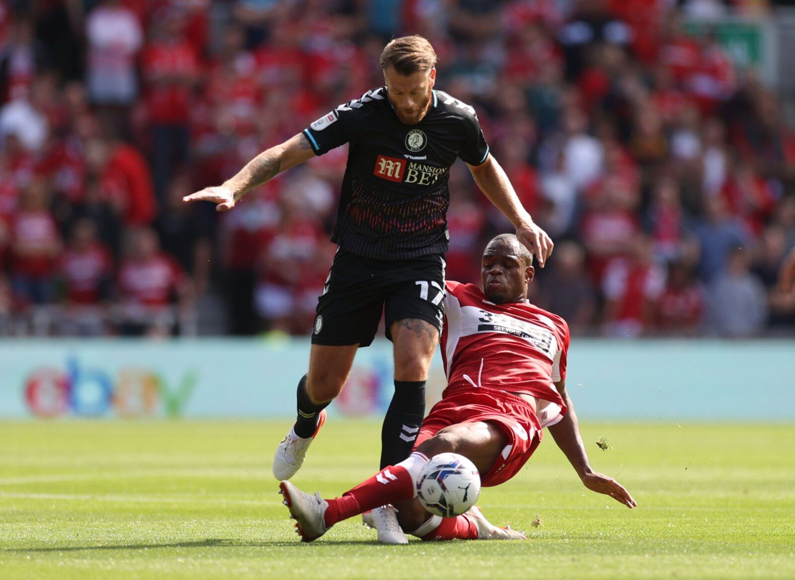 Soccer Football - Championship - Middlesbrough v Bristol City - Riverside Stadium, Middlesbrough, Britain - August 14, 2021 Middlesbrough's Uche Ikpeazu in action with Bristol City's Nathan Baker Action Images/Lee Smith EDITORIAL USE ONLY. No use with unauthorized audio, video, data, fixture lists, club/league logos or 'live' services. Online in-match use limited to 75 images, no video emulation. No use in betting, games or single club /league/player publications.  Please contact your account re