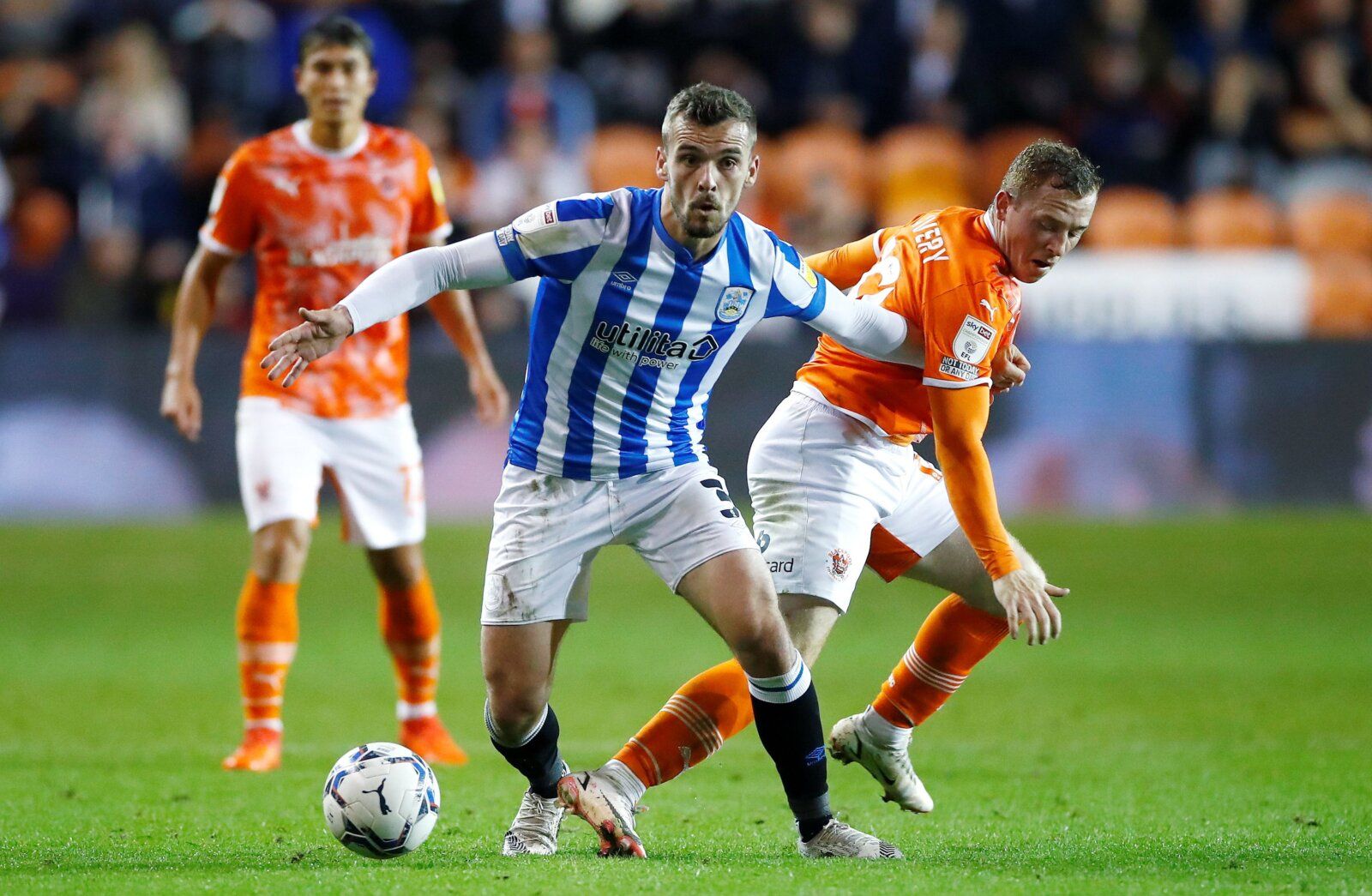 Soccer Football - Championship - Blackpool v Huddersfield Town - Bloomfield Road, Blackpool, Britain - September 14, 2021 Huddersfield Town's Harry Toffolo in action with Blackpool's Shayne Lavery Action Images/Jason Cairnduff