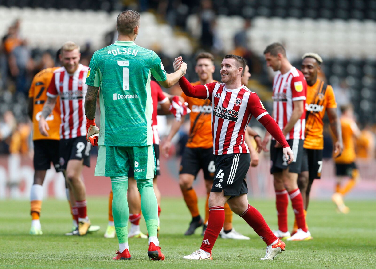 Soccer Football - Championship - Hull City v Sheffield United - KCOM Stadium, Hull, Britain - September 18, 2021 Sheffield United's John Fleck and Robin Olsen celebrate after the game Action Images/Ed Sykes EDITORIAL USE ONLY. No use with unauthorized audio, video, data, fixture lists, club/league logos or 'live' services. Online in-match use limited to 75 images, no video emulation. No use in betting, games or single club /league/player publications.  Please contact your account representative 