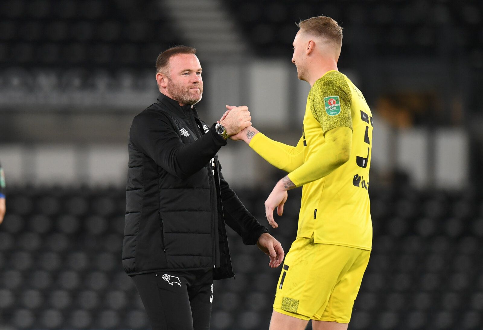 DERBY, ENGLAND - AUGUST 10: Derby County Manager Wayne Rooney congratulates Ryan Allsop of Derby County after his team won the penalty shoot out during the Carabao Cup First Round match between Derby County and Salford City FC at Pride Park Stadium on August 10, 2021 in Derby, England. (Photo by Tony Marshall/Getty Images)
