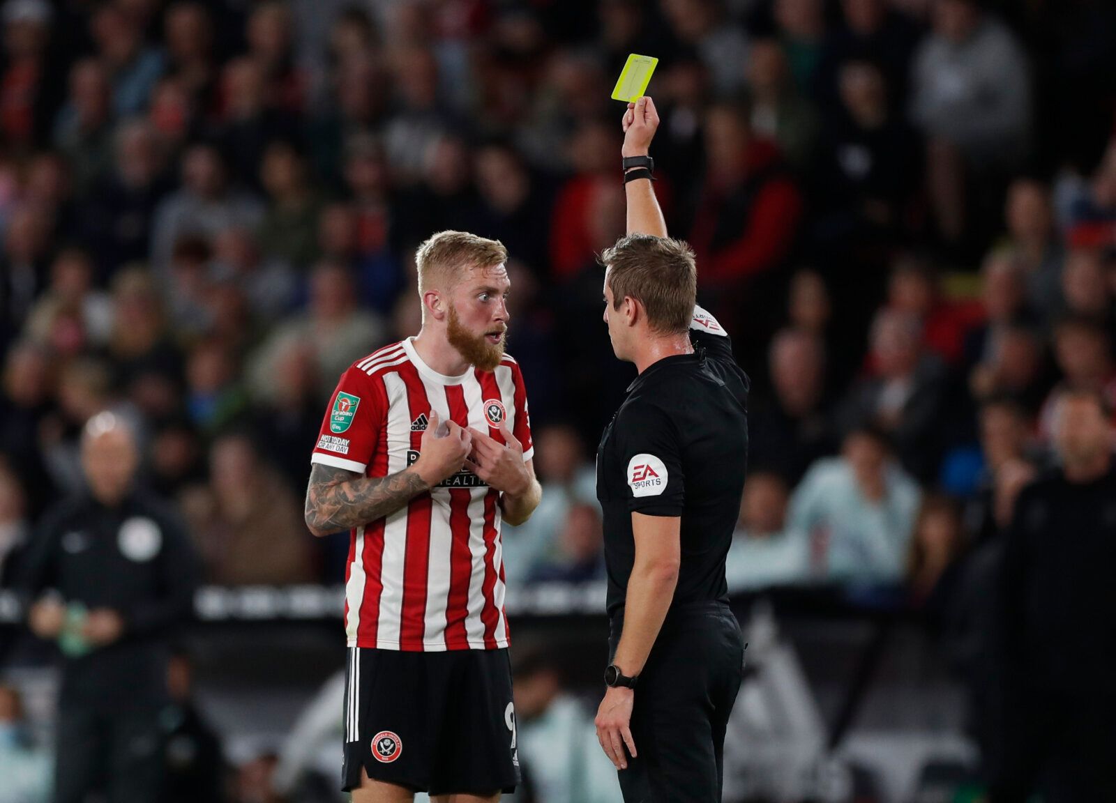 Soccer Football - Carabao Cup - Third Round - Sheffield United v Southampton - Bramall Lane, Sheffield, Britain - September 21, 2021 Sheffield United's Oliver McBurnie is shown a yellow card by referee John Brooks Action Images via Reuters/Lee Smith EDITORIAL USE ONLY. No use with unauthorized audio, video, data, fixture lists, club/league logos or 'live' services. Online in-match use limited to 75 images, no video emulation. No use in betting, games or single club /league/player publications.  