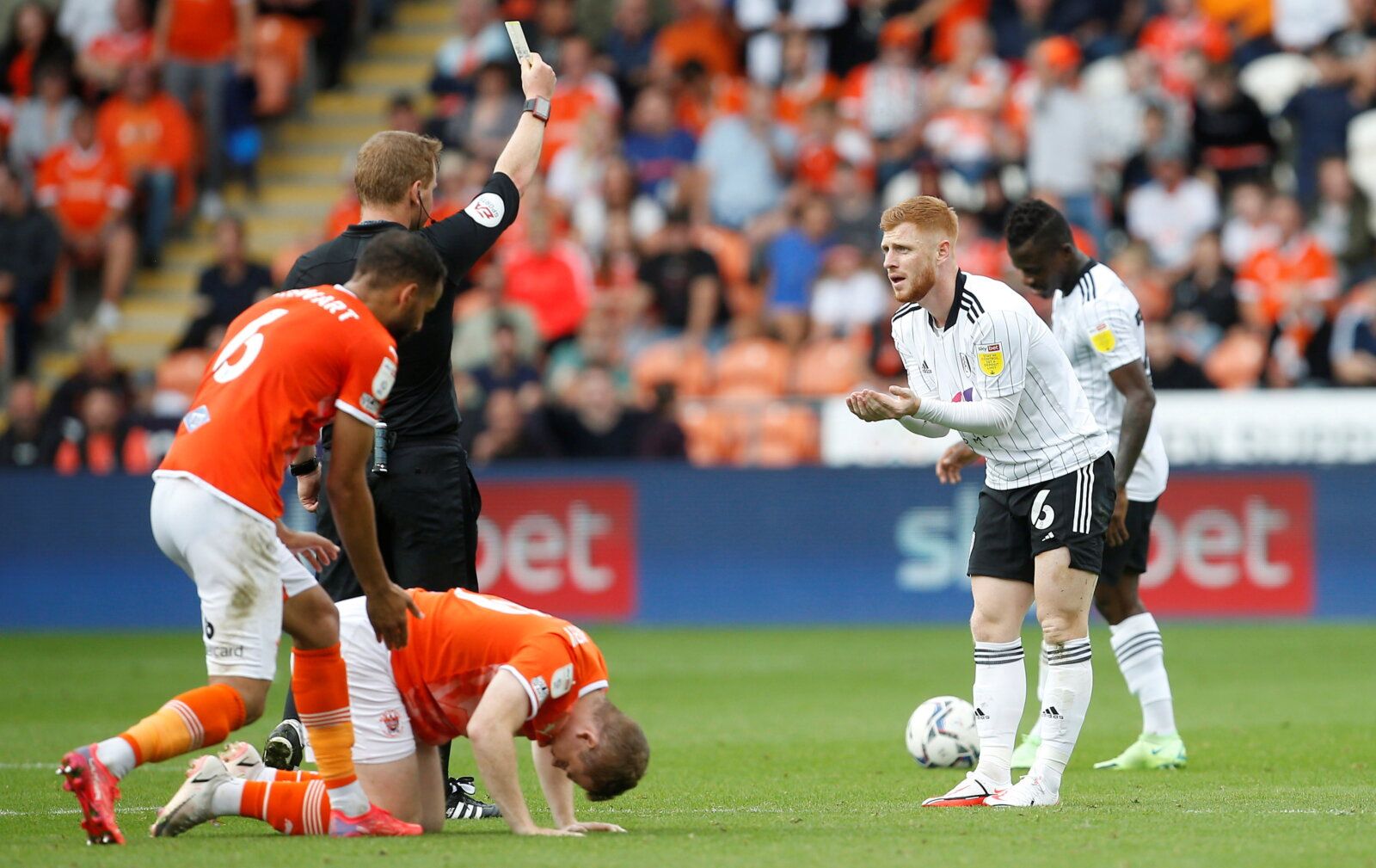 Soccer Football - Championship - Blackpool v Fulham - Bloomfield Road, Blackpool, Britain - September 11, 2021 Fulham's Harrison Reed is shown a yellow card by referee  Action Images/Craig Brough  EDITORIAL USE ONLY. No use with unauthorized audio, video, data, fixture lists, club/league logos or "live" services. Online in-match use limited to 75 images, no video emulation. No use in betting, games or single club/league/player publications.  Please contact your account representative for further