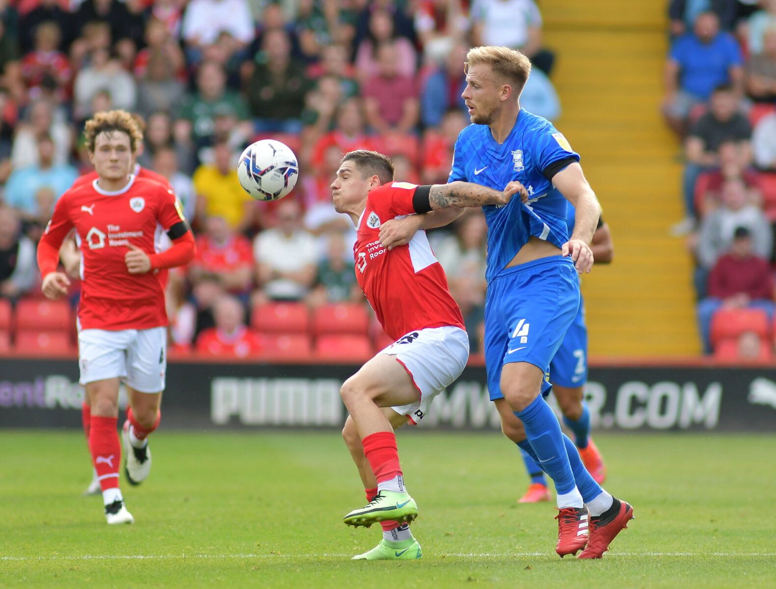Soccer Football - Championship - Barnsley v Birmingham City - Oakwell, Barnsley, Britain - August 28, 2021  Barnsley's Dominik Frieser in action with Birmingham City's Marc Roberts  Action Images/Paul Burrows    EDITORIAL USE ONLY. No use with unauthorized audio, video, data, fixture lists, club/league logos or "live" services. Online in-match use limited to 75 images, no video emulation. No use in betting, games or single club/league/player publications.  Please contact your account representat