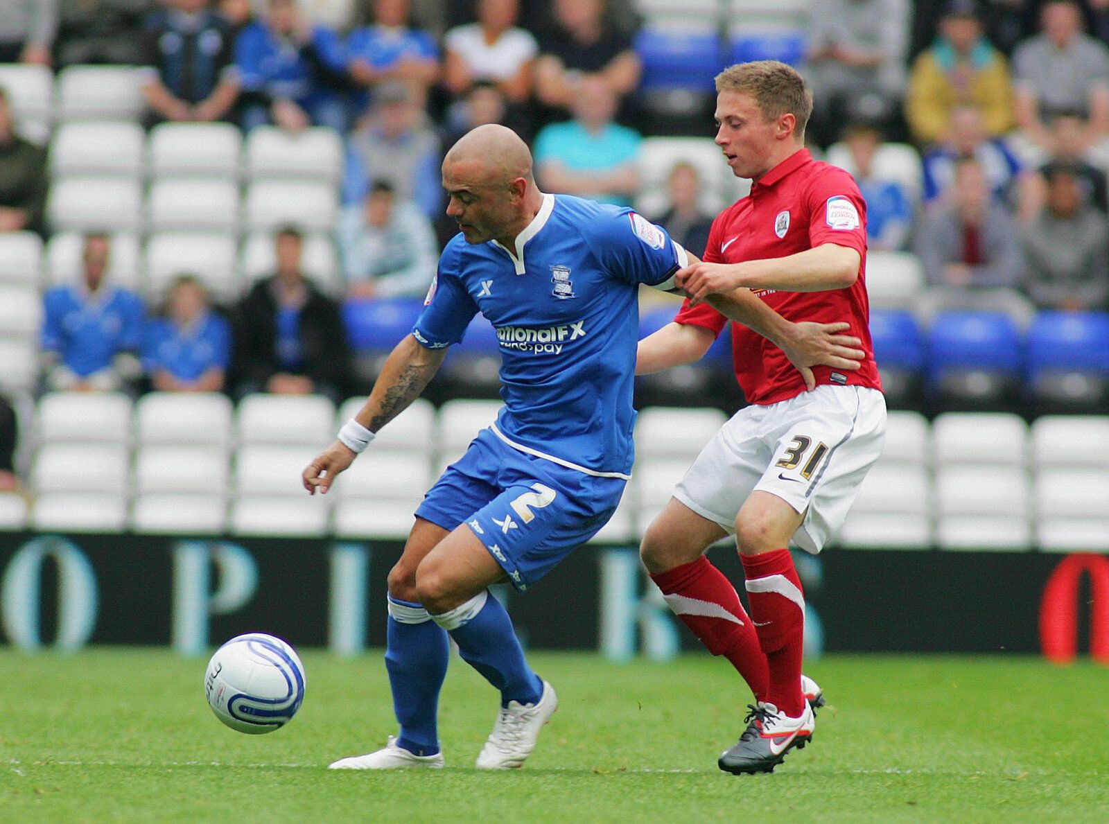 Football - Birmingham City v Barnsley npower Football League Championship  - St Andrews - 24/9/11 
Birmingham's Stephen Carr (L) and Barnsley's Jordan Clark in action 
Mandatory Credit: Action Images / David Field 
Livepic 
EDITORIAL USE ONLY. No use with unauthorized audio, video, data, fixture lists, club/league logos or live services. Online in-match use limited to 45 images, no video emulation. No use in betting, games or single club/league/player publications.  Please contact your account m
