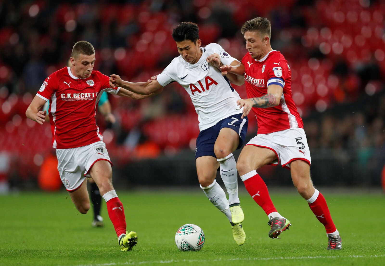 Soccer Football - Carabao Cup Third Round - Tottenham Hotspur vs Barnsley - Wembley Stadium, London, Britain - September 19, 2017   Tottenham's Son Heung-min in action with Barnsley's Angus MacDonald and Joe Williams    Action Images via Reuters/Matthew Childs   EDITORIAL USE ONLY. No use with unauthorized audio, video, data, fixture lists, club/league logos or 