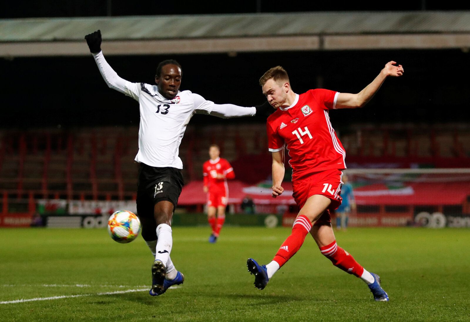 Soccer Football - International Friendly - Wales v Trinidad and Tobago - The Racecourse, Wrexham, Britain - March 20, 2019  Trinidad and Tobago's Nathan Lewis in action with Wales' Ryan Hedges   Action Images via Reuters/Andrew Boyers