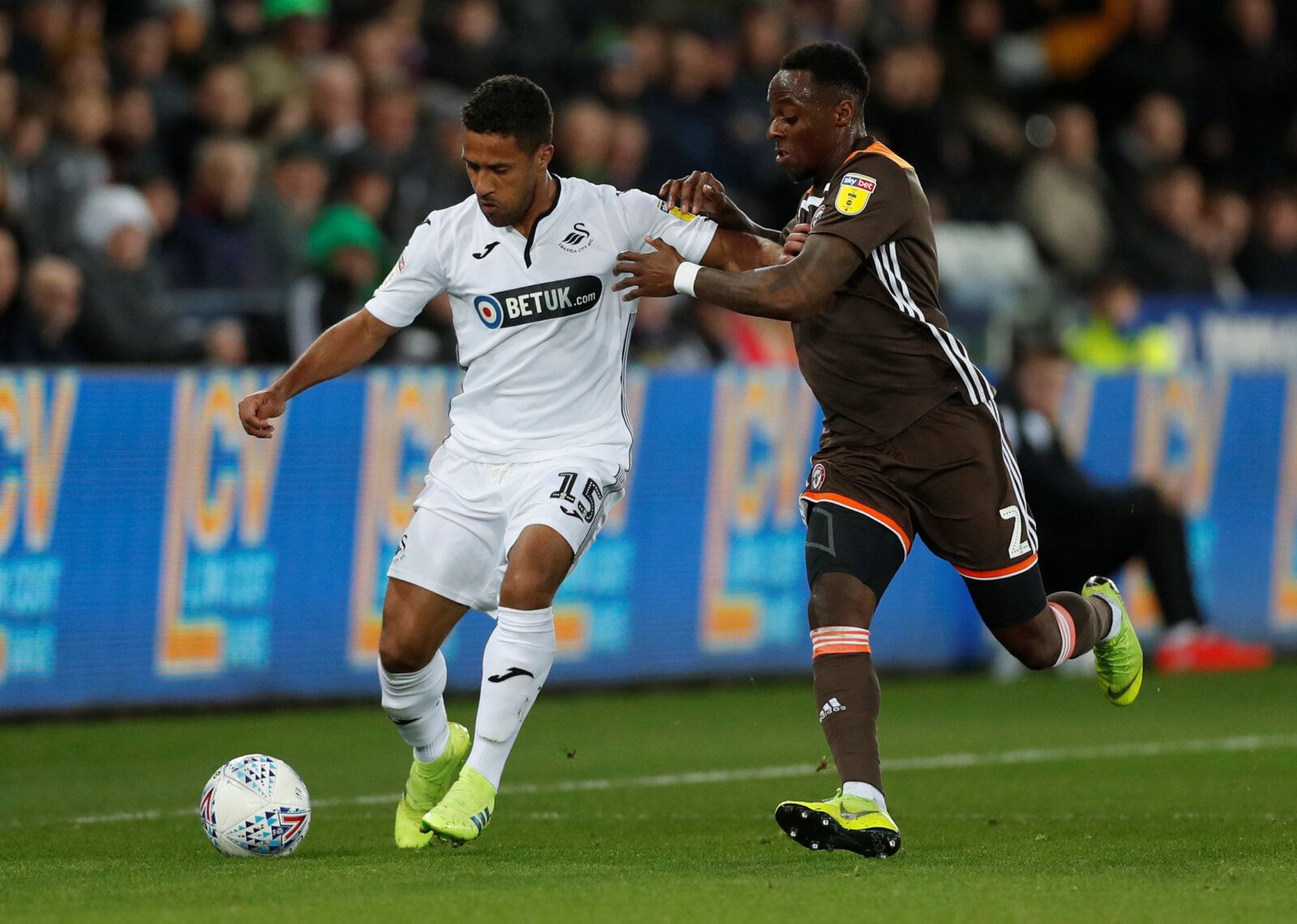 Soccer Football - Championship - Swansea City v Brentford - Liberty Stadium, Swansea, Britain - April 2, 2019   Wayne Routledge of Swansea City in action with Moses Odubajo of Brentford     Action Images/Matthew Childs    EDITORIAL USE ONLY. No use with unauthorized audio, video, data, fixture lists, club/league logos or 