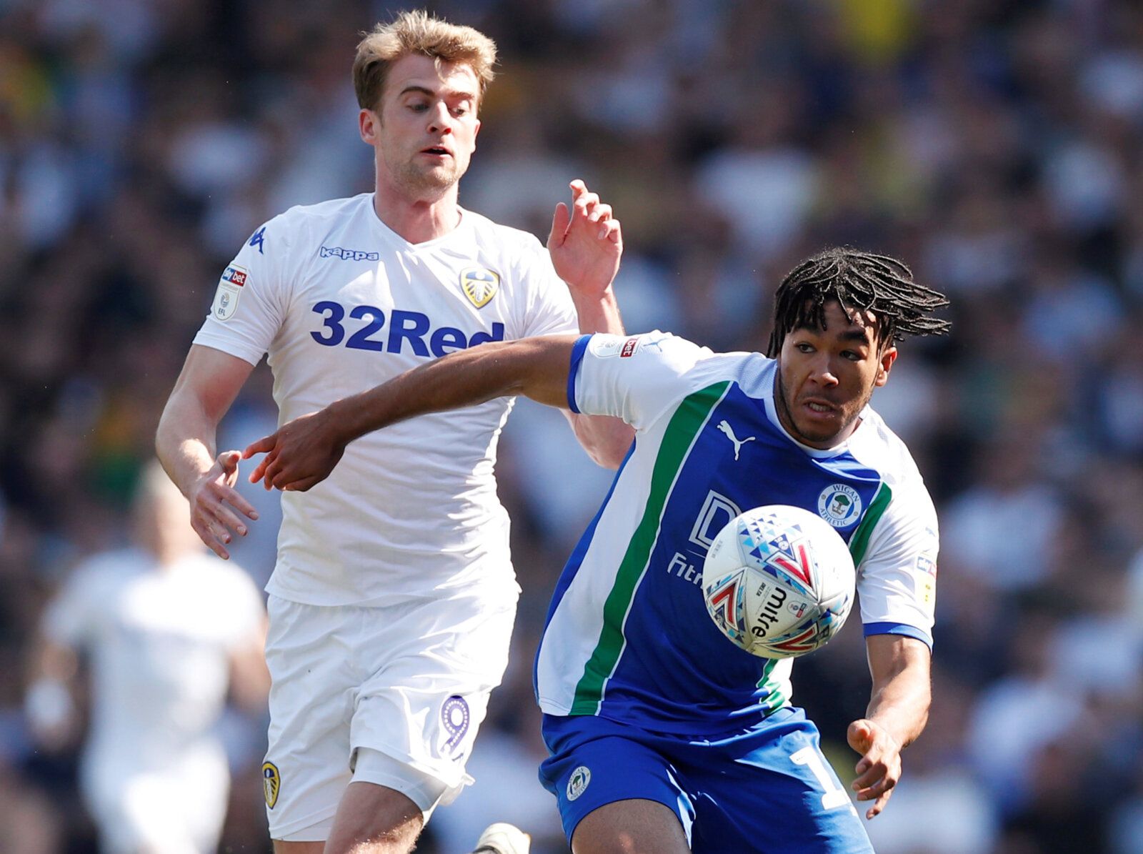 Soccer Football - Championship - Leeds United v Wigan Athletic - Elland Road, Leeds, Britain - April 19, 2019   Leeds' Patrick Bamford in action with Wigan's Reece James    Action Images/Andrew Boyers    EDITORIAL USE ONLY. No use with unauthorized audio, video, data, fixture lists, club/league logos or 