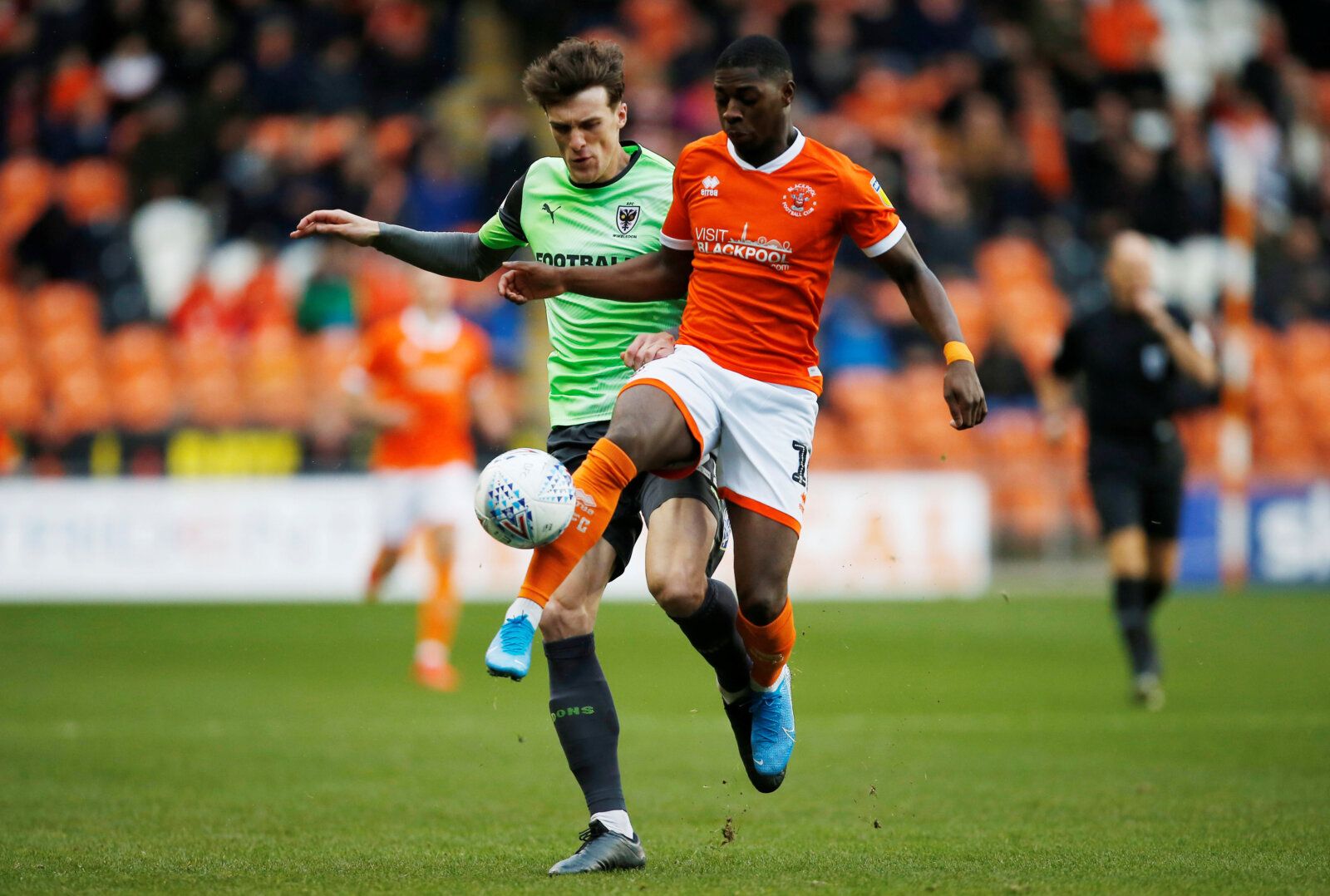 Soccer Football - League One - Blackpool v AFC Wimbledon - Bloomfield Road, Blackpool, Britain - November 16, 2019   AFC Wimbledon's Ryan Delaney in action with Blackpool's Sullay Kaikai   Action Images/Craig Brough    EDITORIAL USE ONLY. No use with unauthorized audio, video, data, fixture lists, club/league logos or 