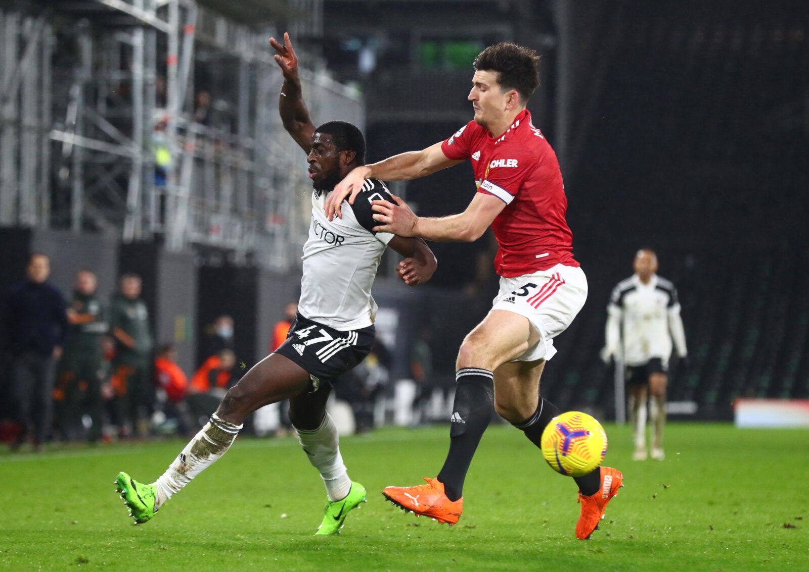 Soccer Football - Premier League - Fulham v Manchester United - Craven Cottage, London, Britain - January 20, 2021 Fulham's Aboubakar Kamara in action with Manchester United's Harry Maguire Pool via REUTERS/Clive Rose EDITORIAL USE ONLY. No use with unauthorized audio, video, data, fixture lists, club/league logos or 'live' services. Online in-match use limited to 75 images, no video emulation. No use in betting, games or single club /league/player publications.  Please contact your account repr