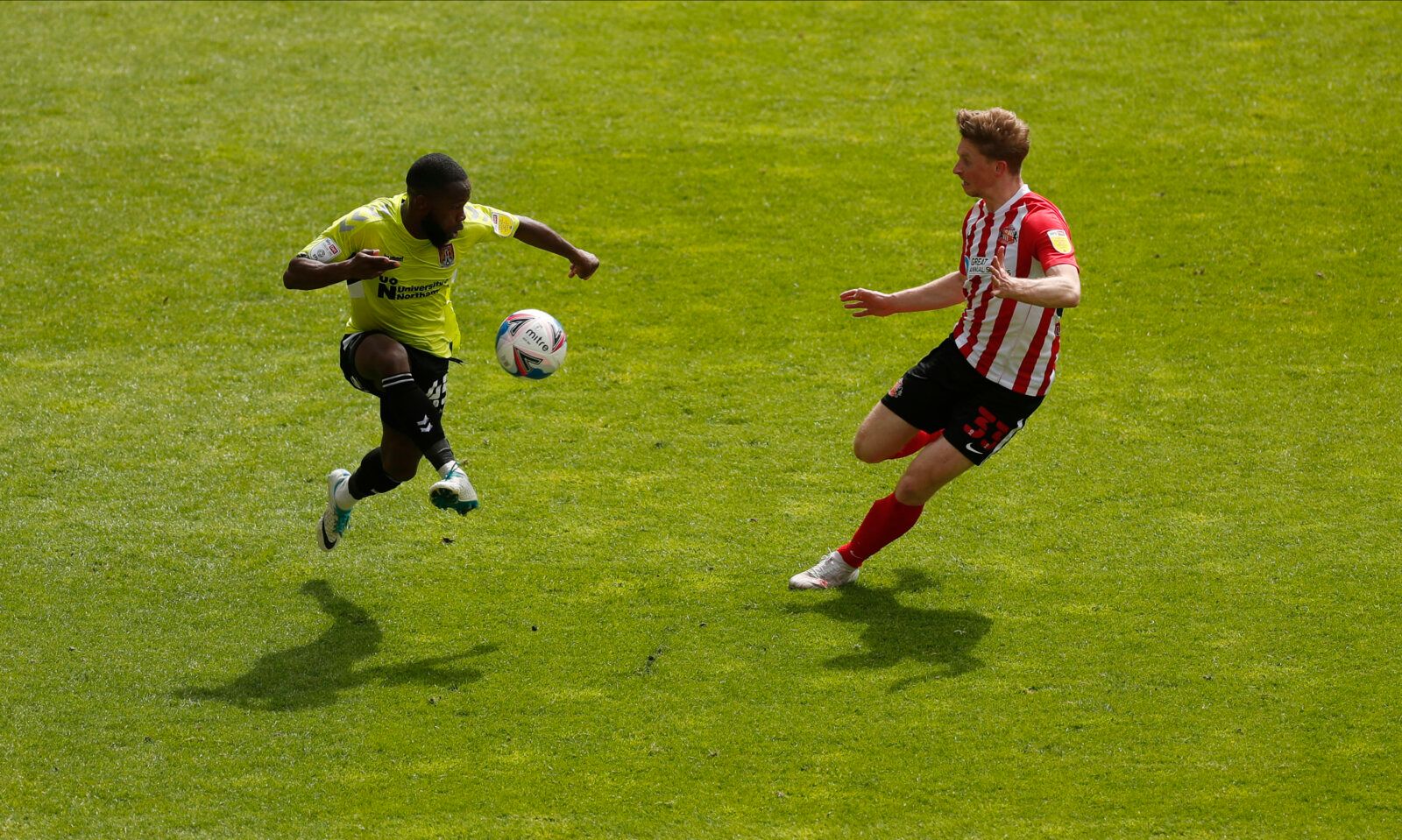 Soccer Football - League One - Sunderland v Northampton Town - Stadium of Light, Sunderland, Britain - May 9, 2021 Sunderland's Denver Hume in action with Northampton's Mark Marshall Action Images/Lee Smith EDITORIAL USE ONLY. No use with unauthorized audio, video, data, fixture lists, club/league logos or 'live' services. Online in-match use limited to 75 images, no video emulation. No use in betting, games or single club /league/player publications.  Please contact your account representative 