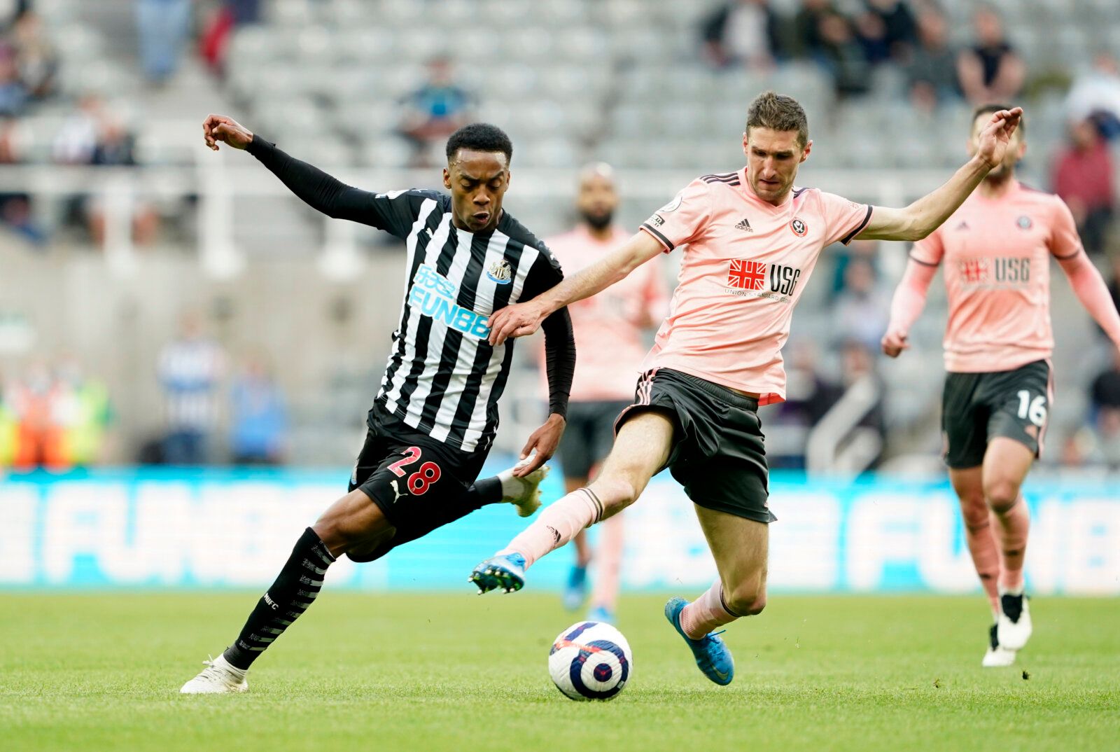 Soccer Football - Premier League - Newcastle United v Sheffield United - St James' Park, Newcastle, Britain - May 19, 2021 Newcastle United's Joseph Willock in action with Sheffield United's Chris Basham Pool via REUTERS/Owen Humphreys EDITORIAL USE ONLY. No use with unauthorized audio, video, data, fixture lists, club/league logos or 'live' services. Online in-match use limited to 75 images, no video emulation. No use in betting, games or single club /league/player publications.  Please contact