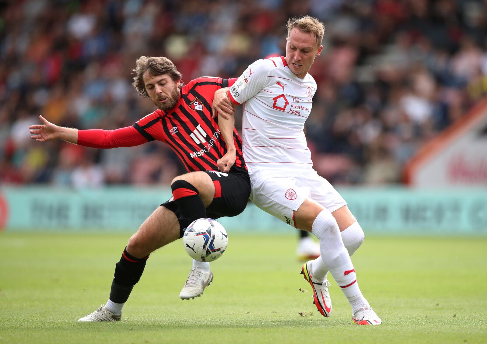 Soccer Football - Championship - AFC Bournemouth v Barnsley - Vitality Stadium, Bournemouth, Britain - September 11, 2021  Bournemouth?s Ben Pearson in action with Barnsley?s Cauley Woodrow  Action Images/Peter Cziborra  EDITORIAL USE ONLY. No use with unauthorized audio, video, data, fixture lists, club/league logos or 